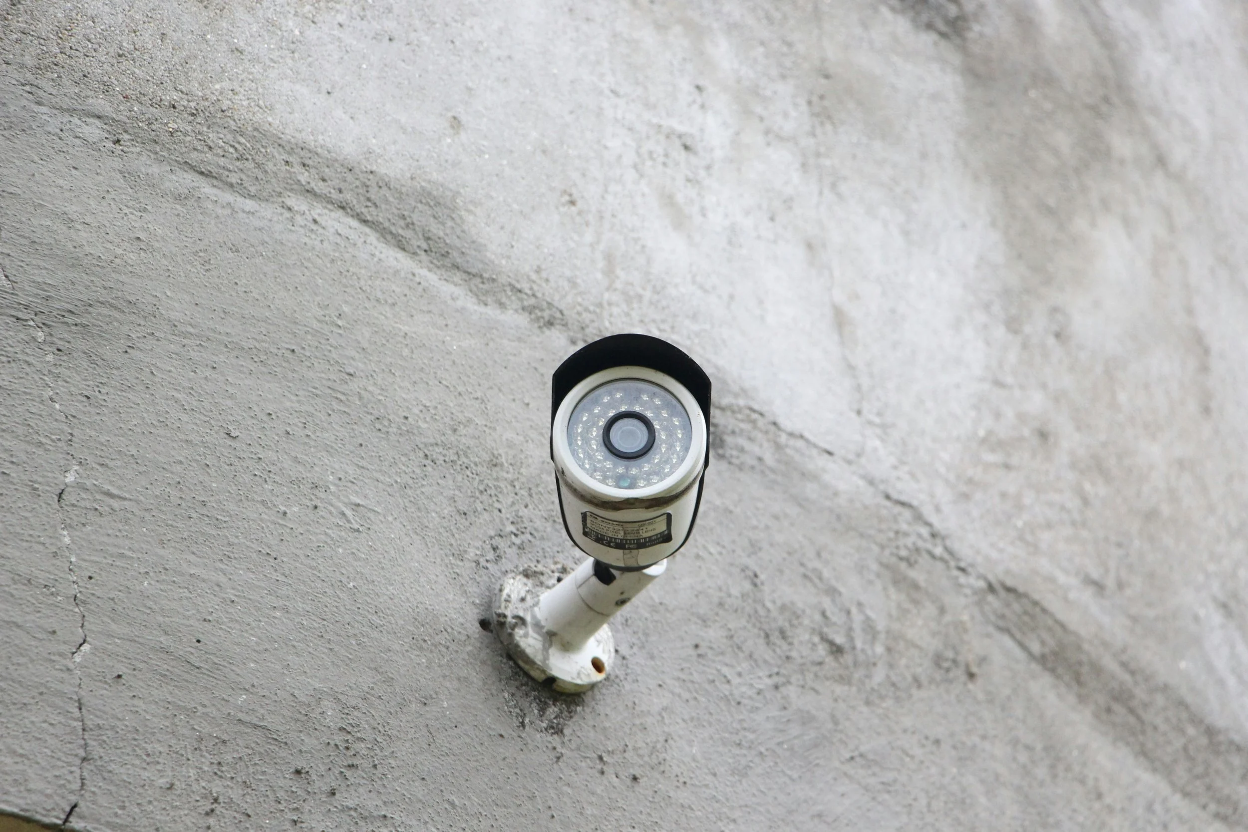 Outdoor security light fixture mounted on a concrete wall.