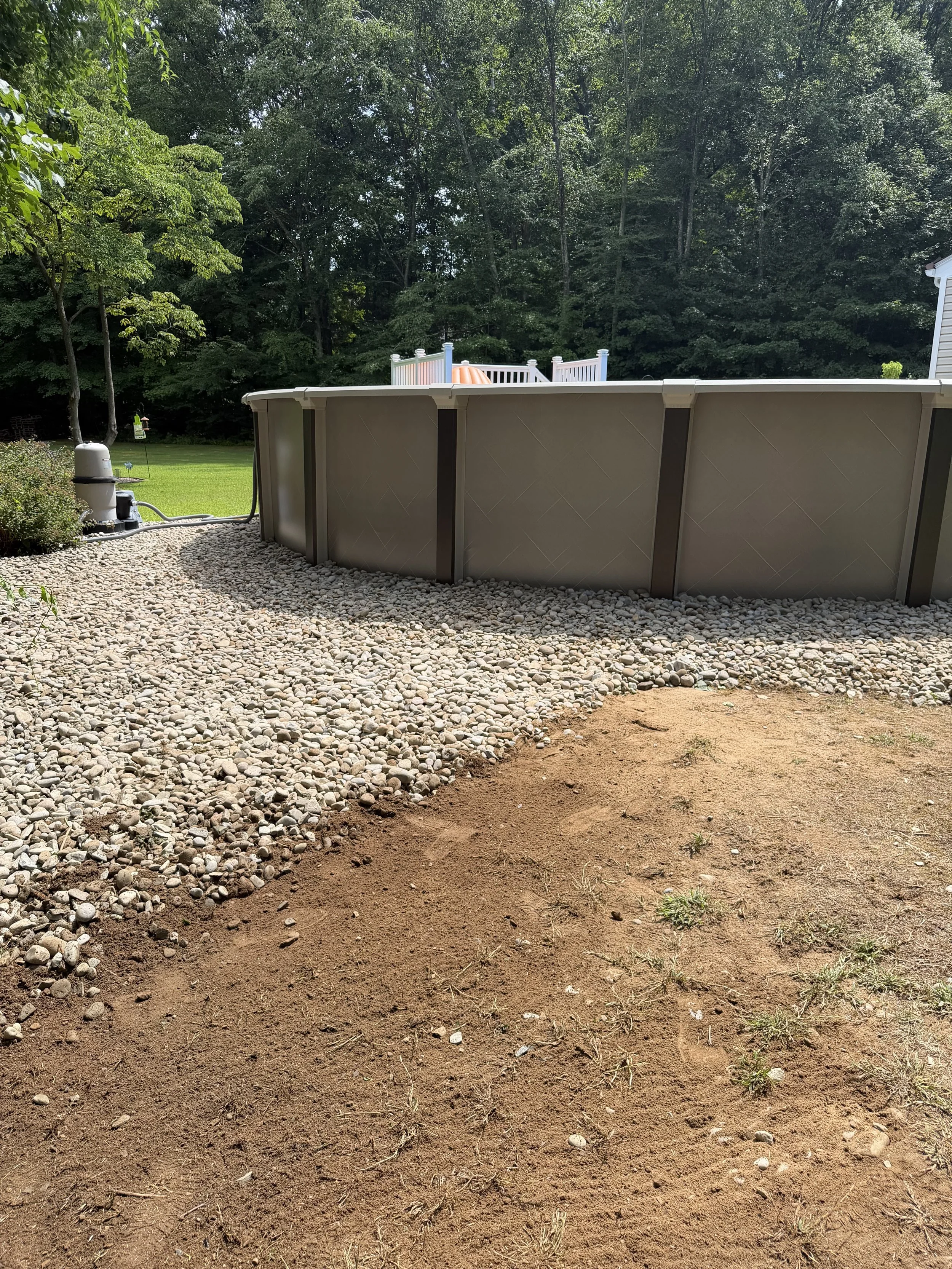 Repair, regrade, and new stone to fix a drainage issue underneath this pool. (After) - Guilford, CT.