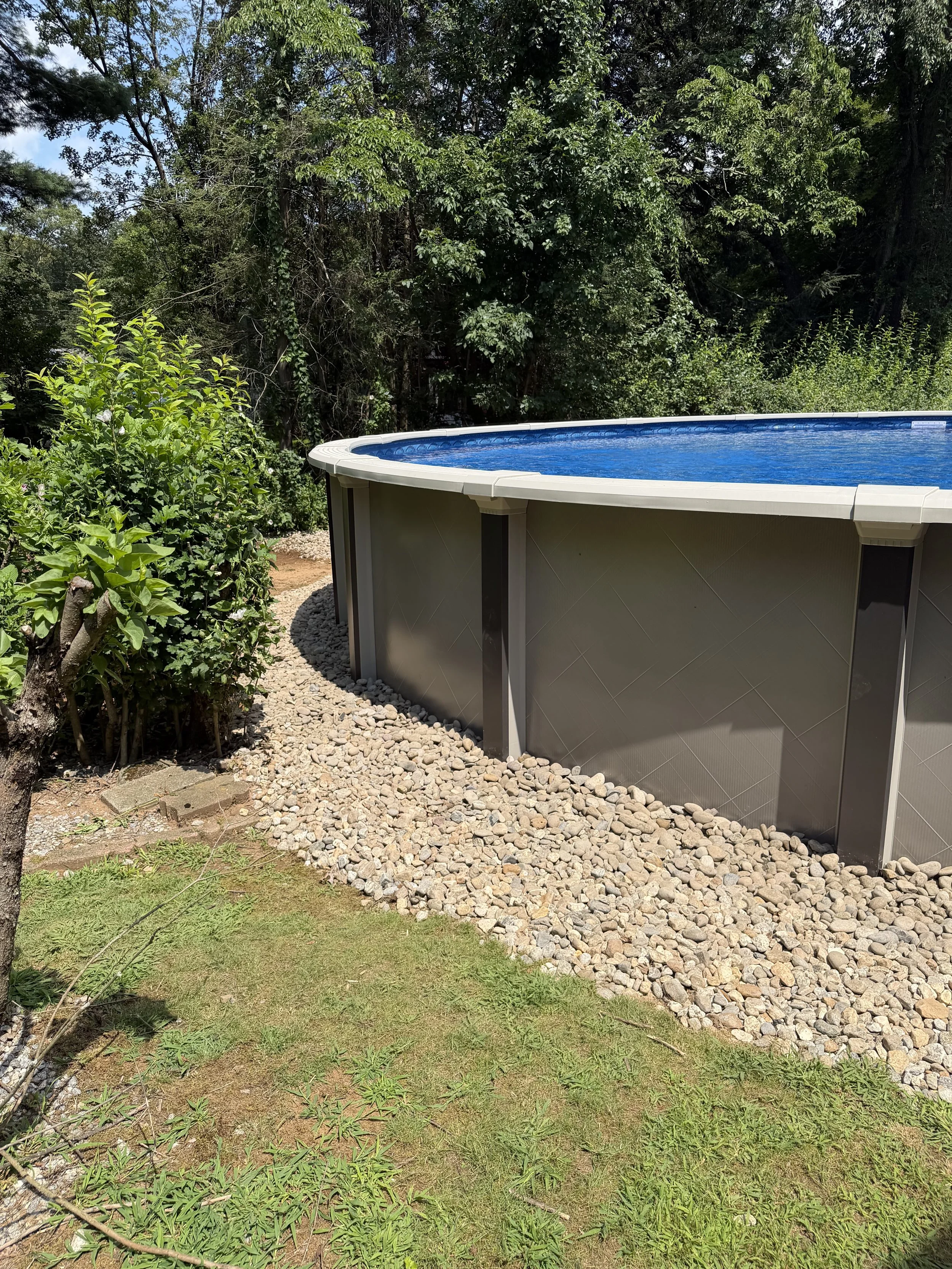 Repair, regrade, and new stone to fix a drainage issue underneath this pool. (After) - Guilford, CT.