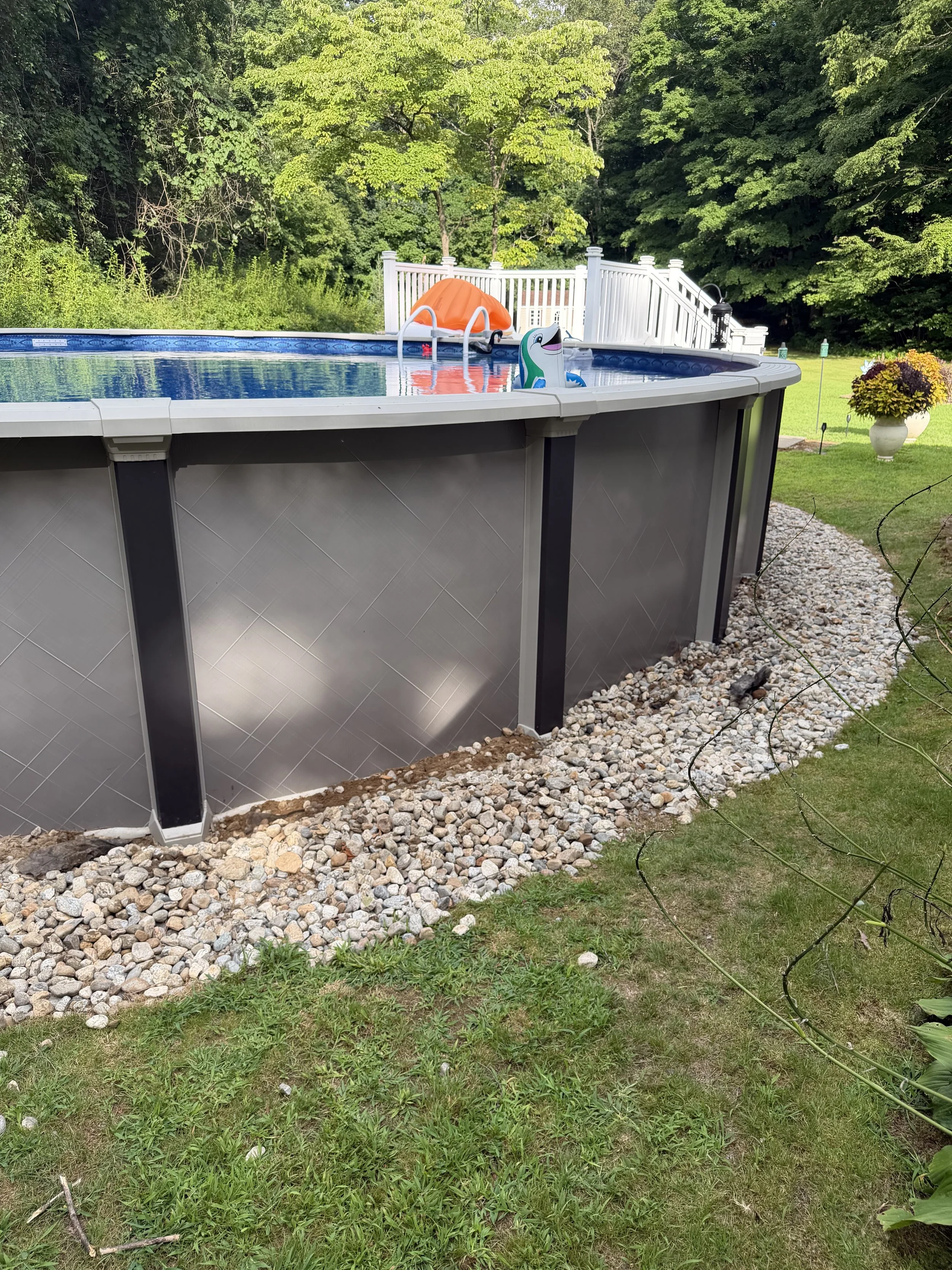 Repair, regrade, and new stone to fix a drainage issue underneath this pool. (Before) - Guilford, CT.