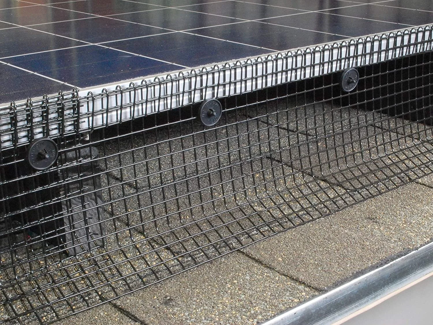 Close-up of a solar-powered outdoor bench with a metal frame, situated on a paved surface at ground level.