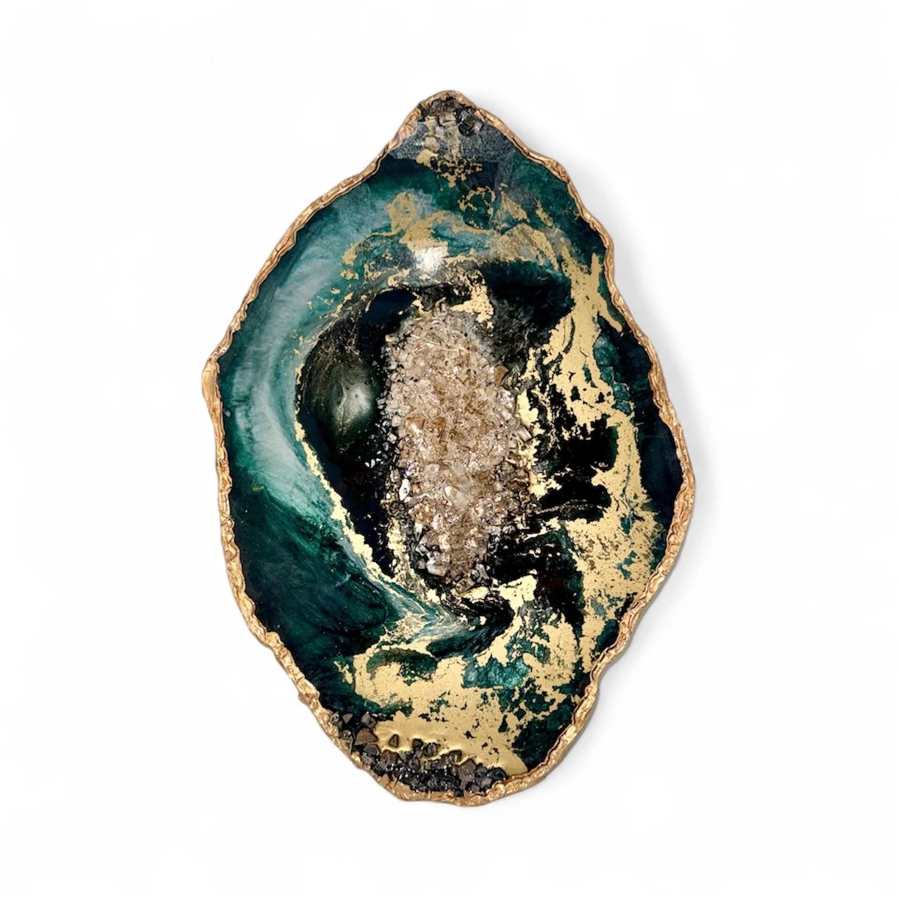 A decorative geode with dark green, black, and gold accents, featuring a crystalline interior and an irregular oval shape with a gold-colored edge.