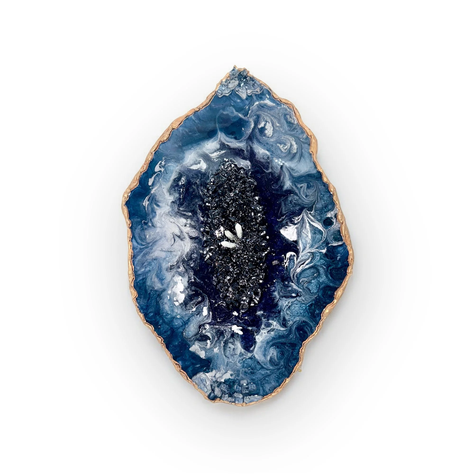 A polished blue and black geode with a gold rim, showing crystalline formations and swirling patterns inside.