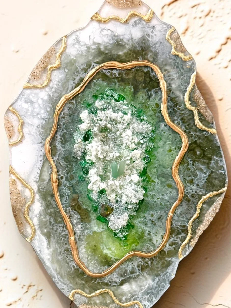 Decorative mineral or gemstone slice with green, white, and gold accents.