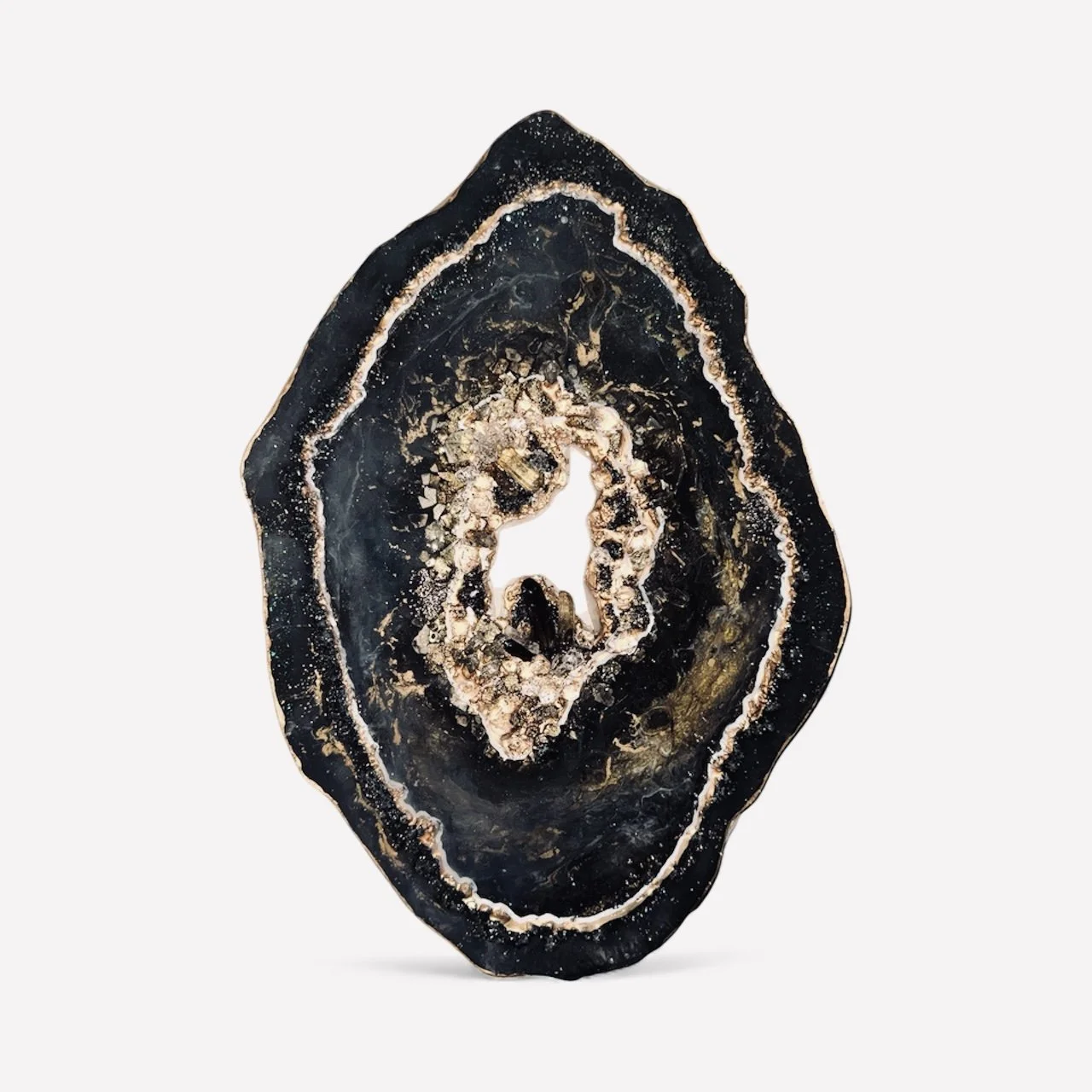 Close-up of a polished black and gold agate gemstone with concentric layers