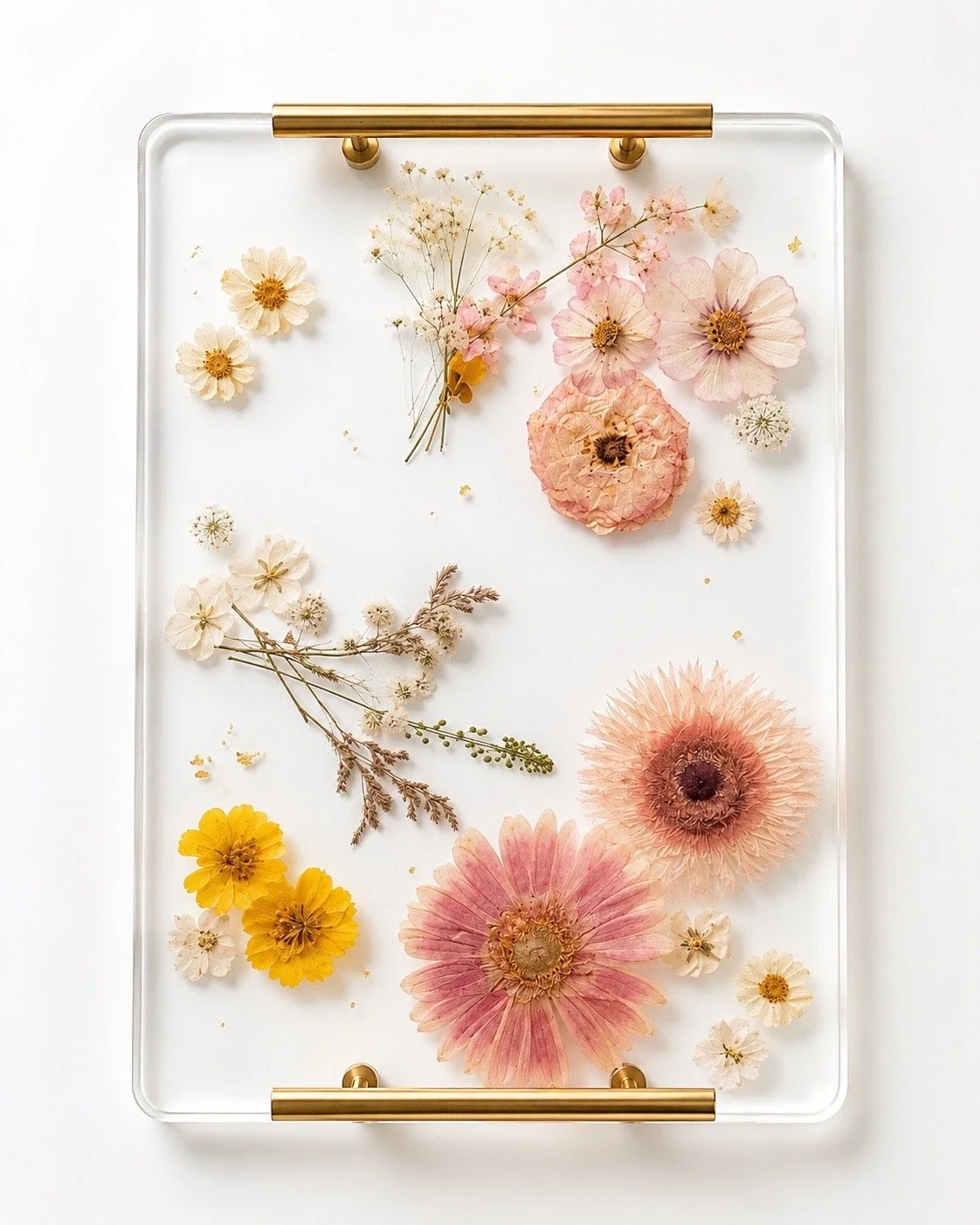 Rectangular clear resin serving tray with gold handles, embedded with pressed pink, yellow and white daisies and baby's breath flowers