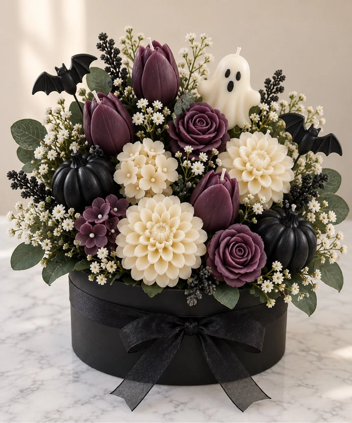 Witch's Spell Halloween candle bouquet with purple roses, ivory dahlias, white ghosts and black accents in a black hat box with black bow