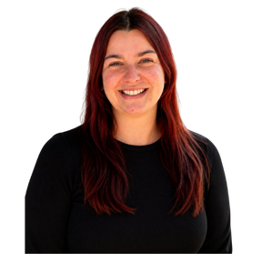 A woman with long red hair, smiling, wearing a black top, against a plain background.