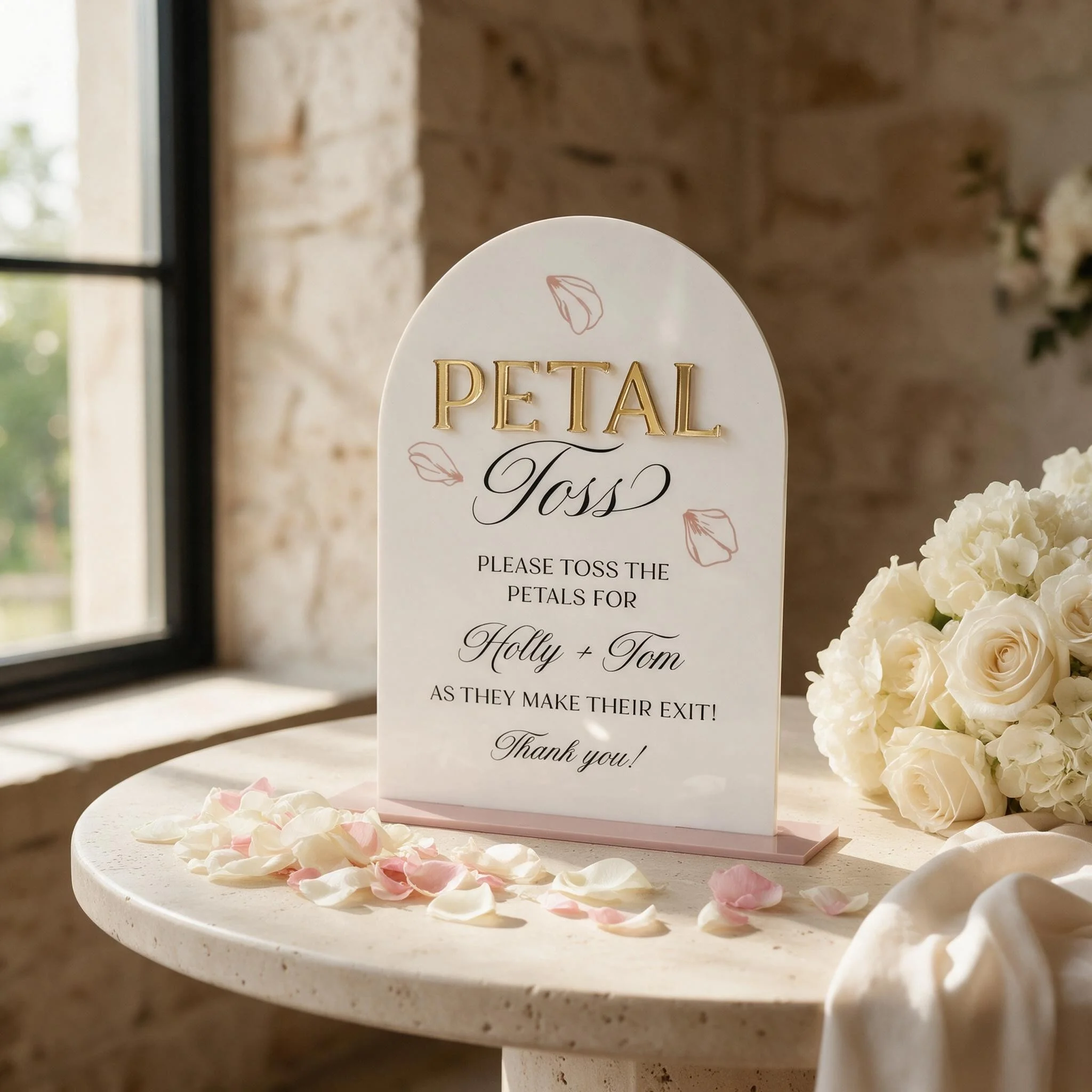 Dome Petal Toss sign displayed with loose flower petals at a wedding