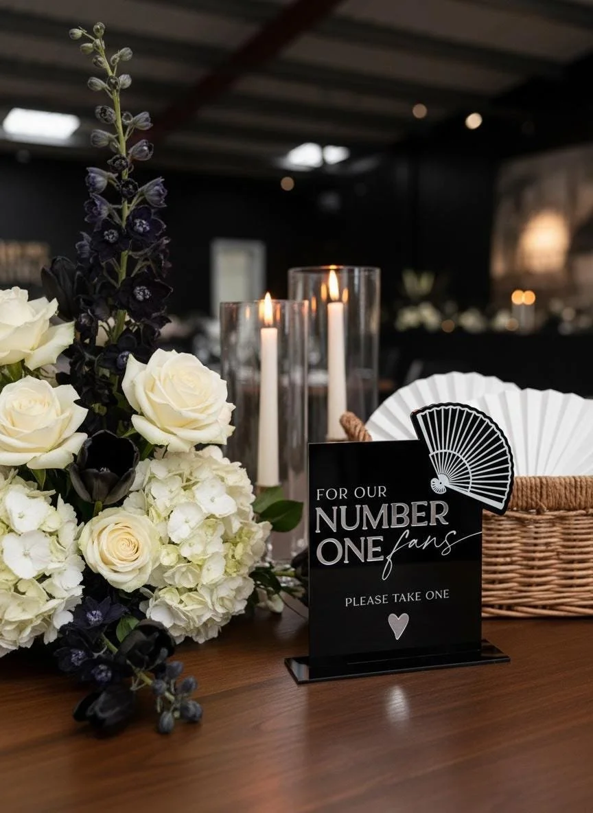 Black acrylic “For Our Number One Fans” sign with white printing and raised detailing.