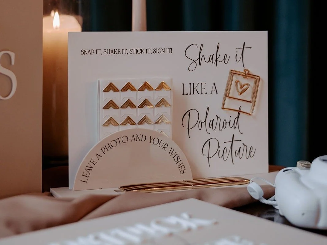 Metallic pens and photo corners included with the acrylic Polaroid guestbook sign.