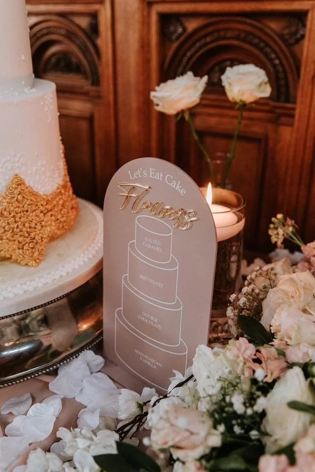 Pink dome wedding cake flavour sign with a printed cake outline and raised rose-gold lettering