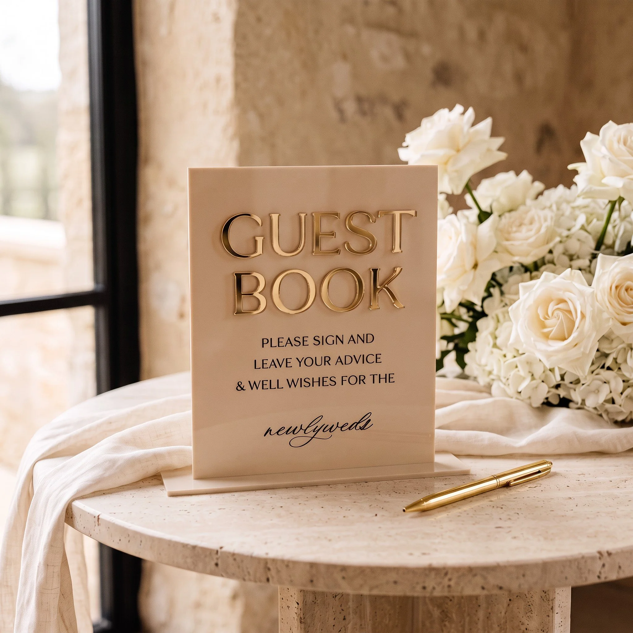 Neutral acrylic sign inviting wedding guests to sign the guestbook