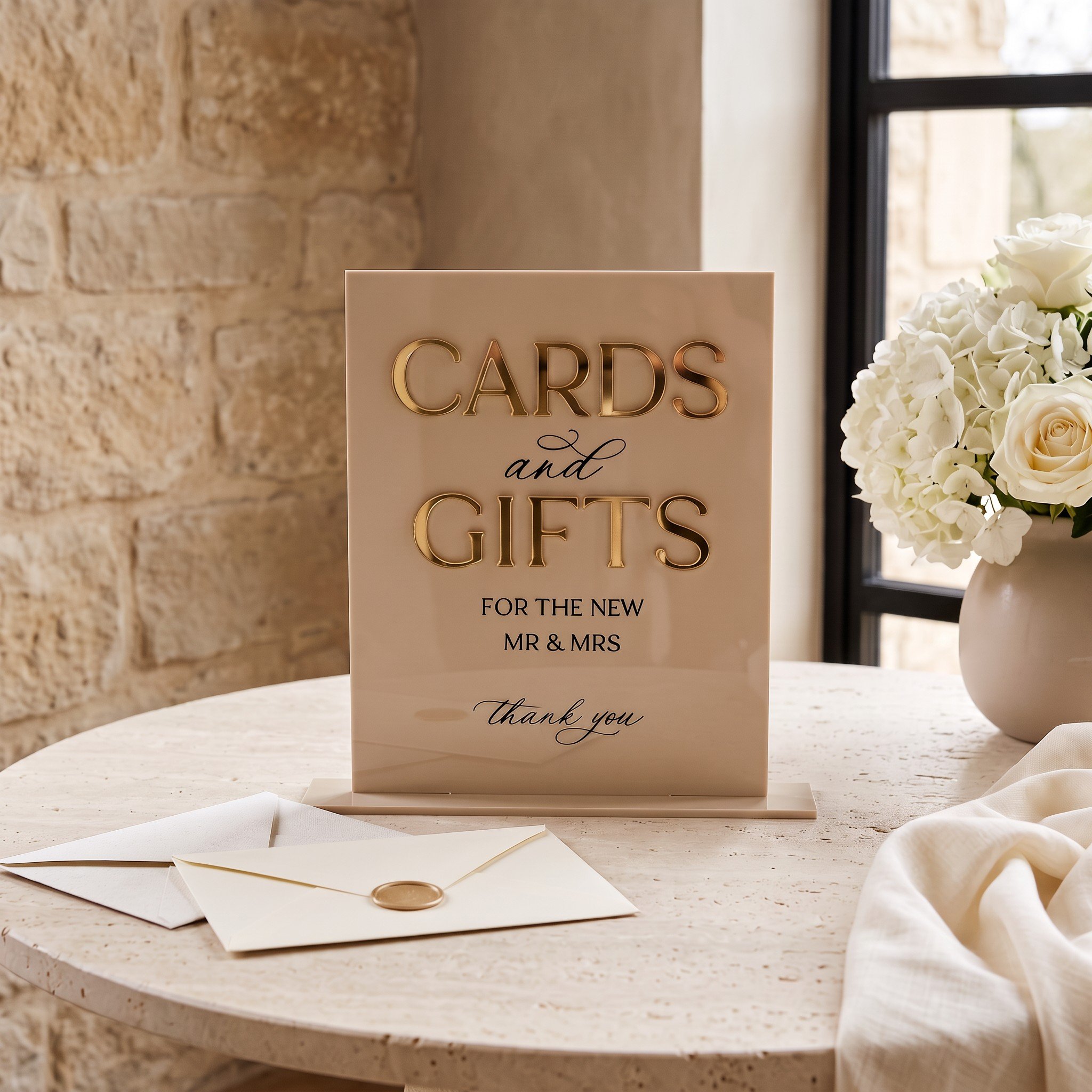 White acrylic Cards and Gifts wedding sign with raised gold mirror lettering on a wedding gift table