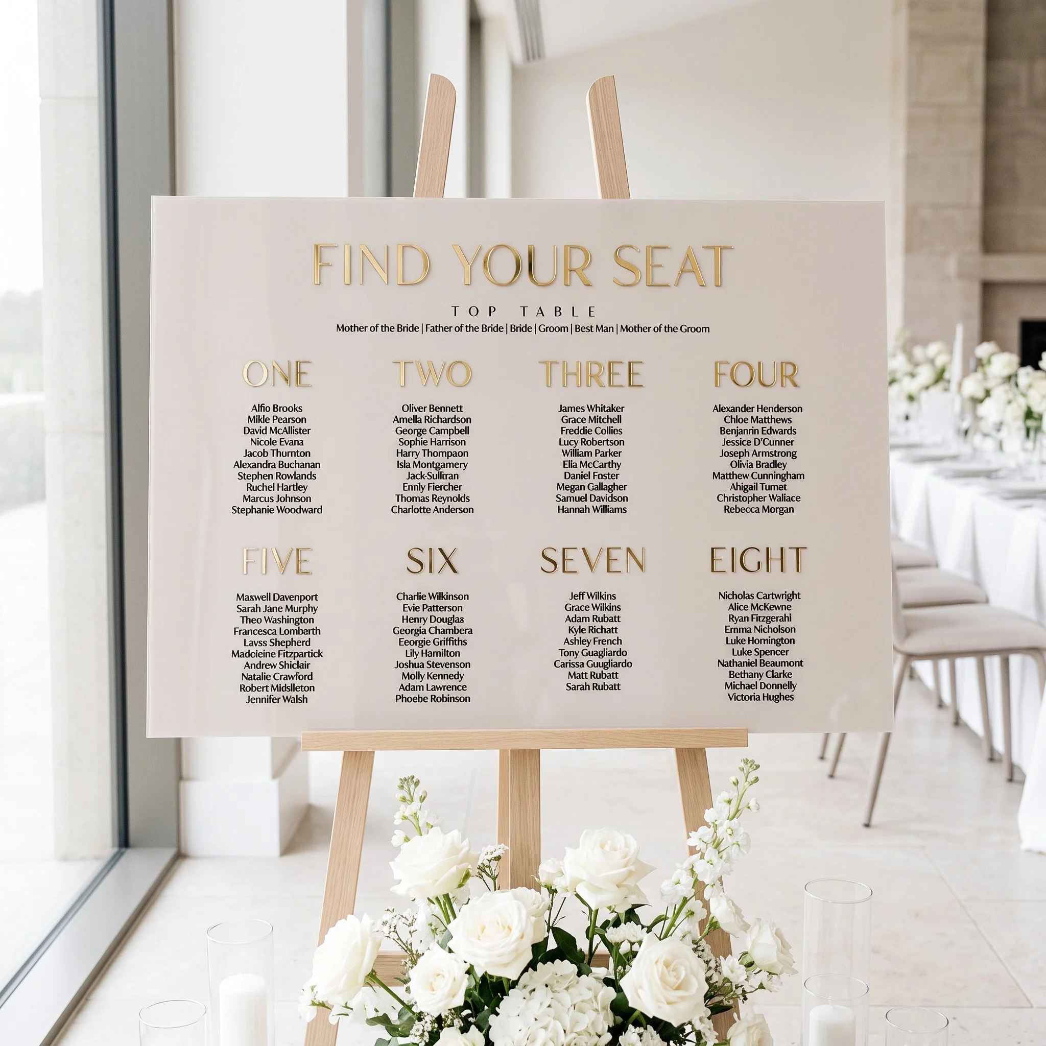 Modern wedding seating chart with raised gold table numbers and black printed guest names
