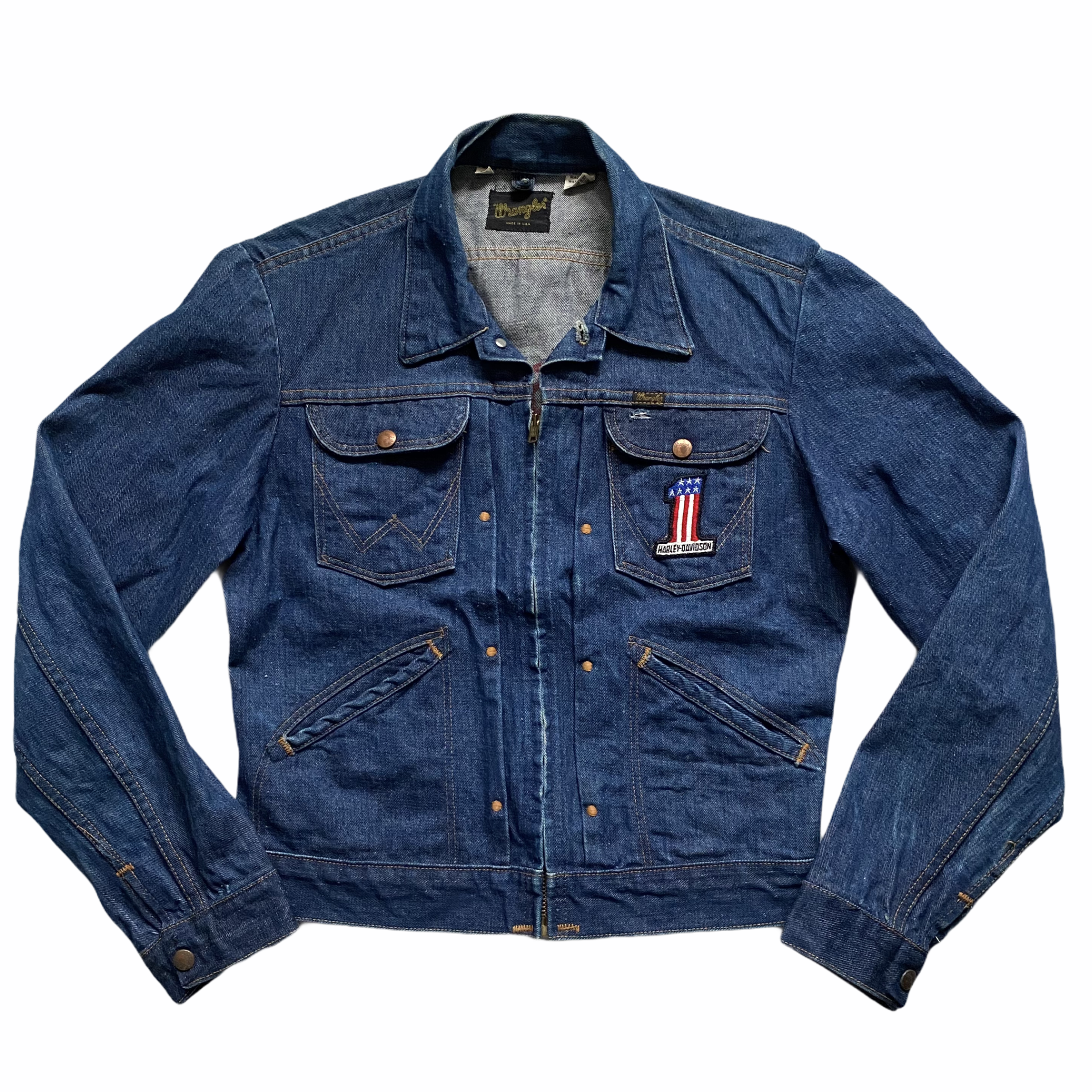 A blue denim jacket with American flag patch on the left pocket and a Harley-Davidson patch on the right pocket, laid out flat on a white background.