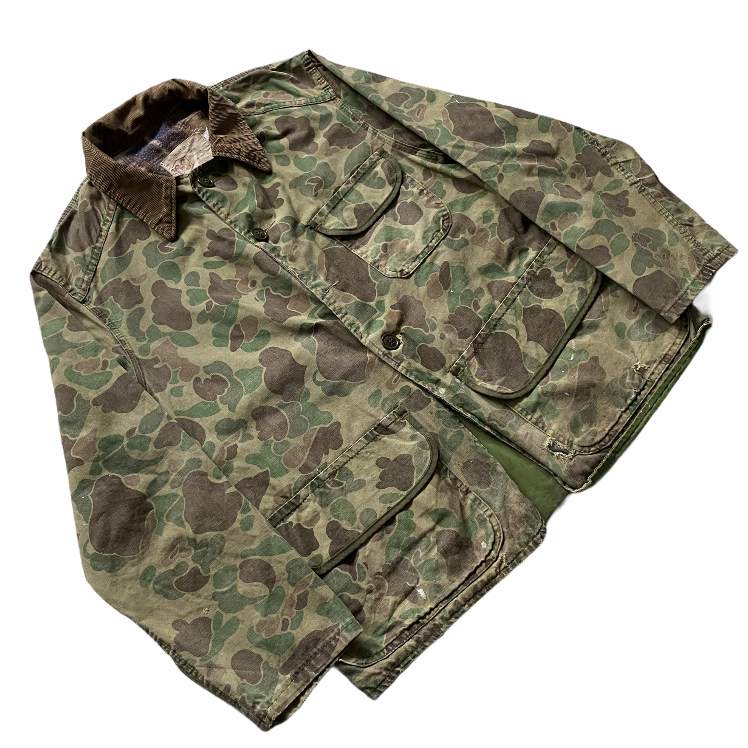 A camouflage military uniform shirt laid flat with the collar and front pockets visible.
