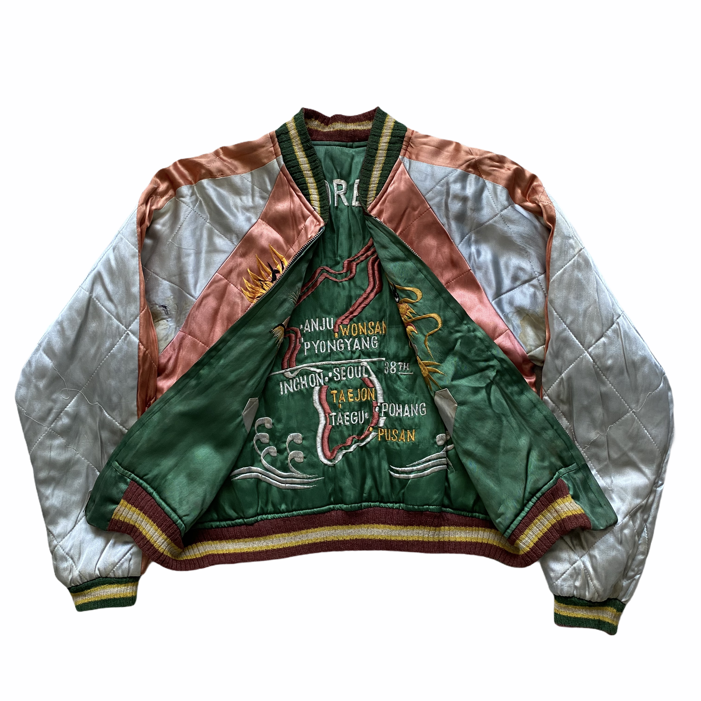 A vintage patchwork bomber jacket with colorful stitched designs, green and red accents, and striped cuffs and collar.