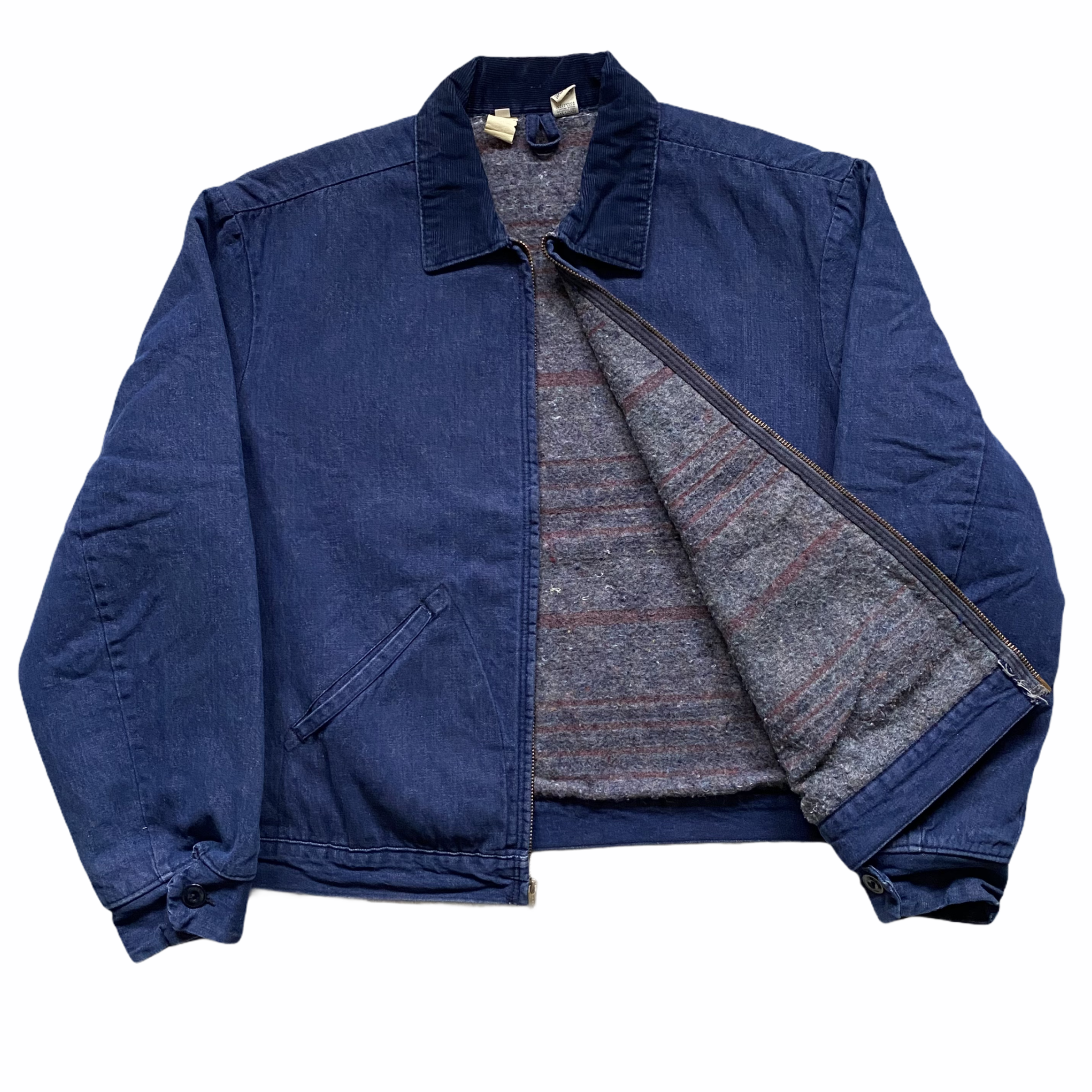 A dark blue denim jacket with a zipper in the front, paired with a patterned sweater underneath, captured against a plain white background.