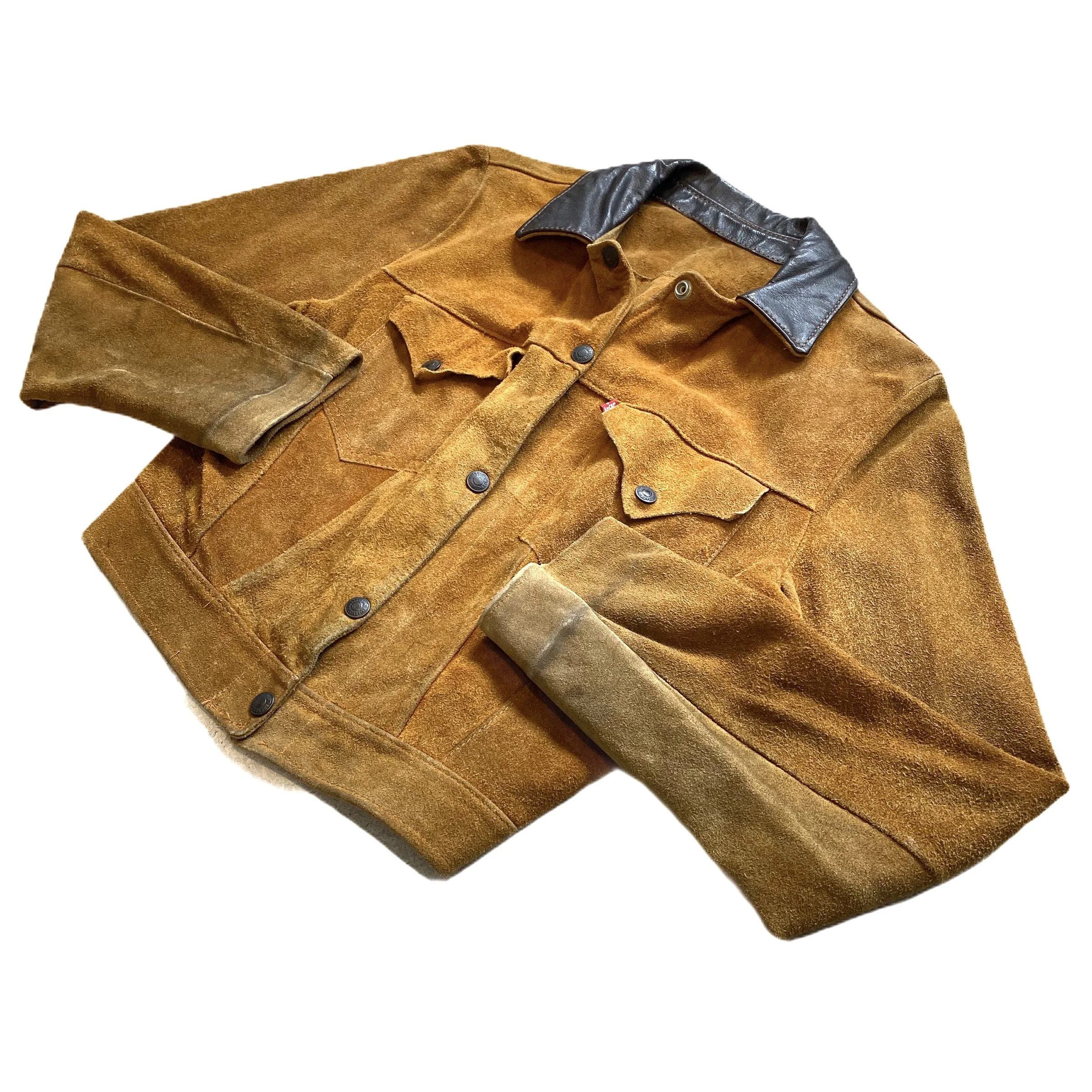 A brown suede shirt with a leather collar and black buttons, folded against a plain white background.