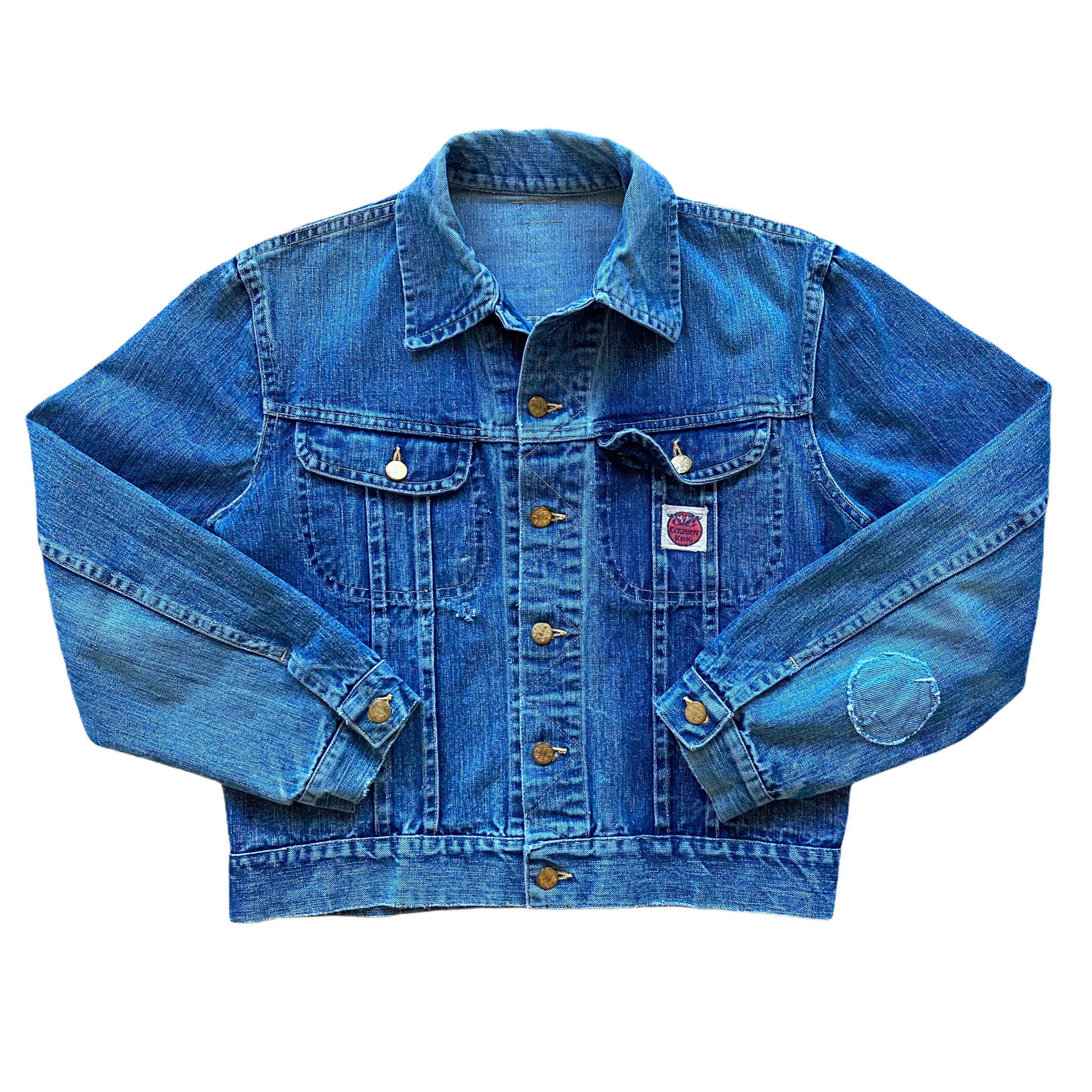 A blue denim jacket with gold buttons, collar, and embroidered graphic patch on the lower left side, laid out flat on a white background.