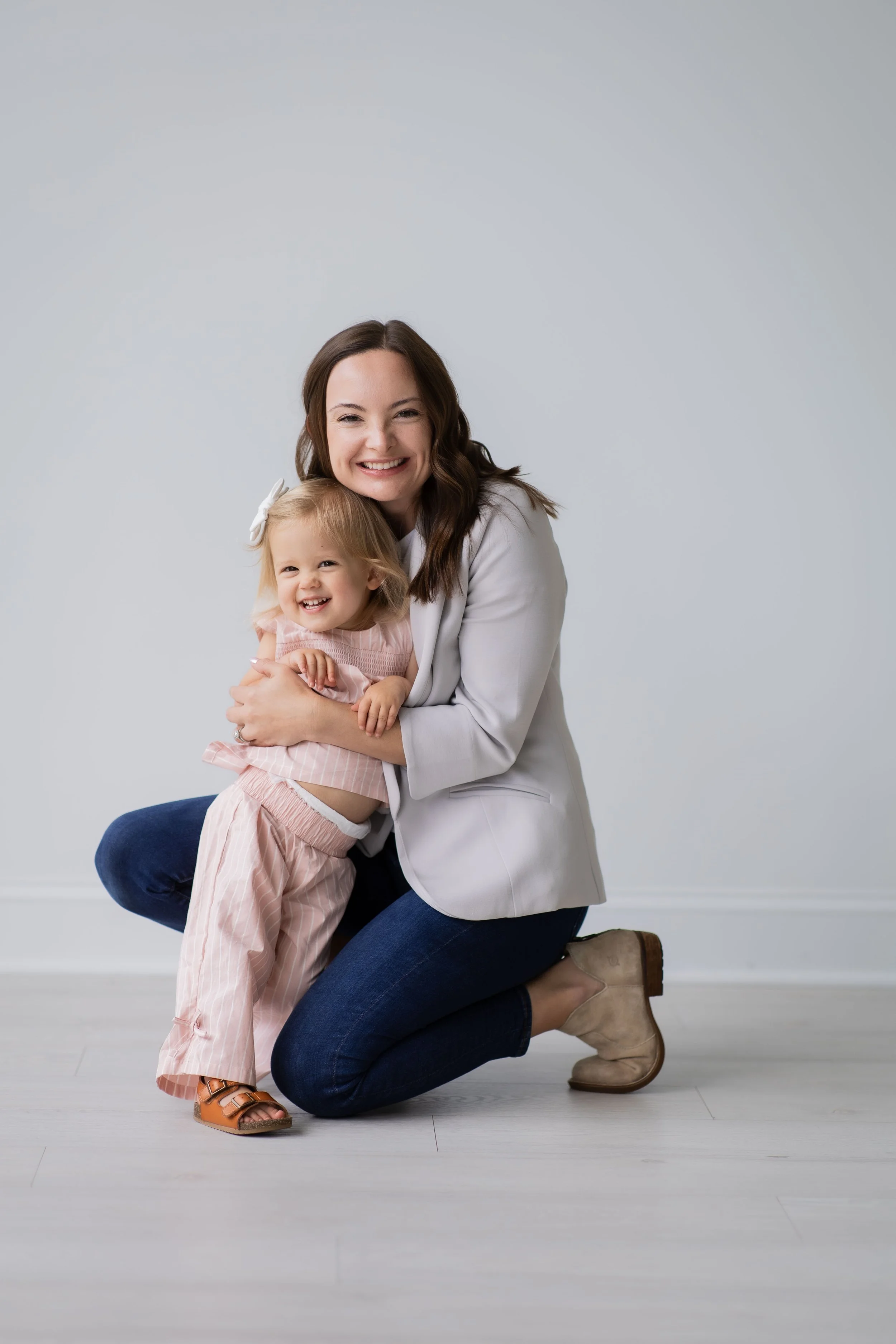 Dr. Taylor Hayes smiling with her young daughter at Woven Chiropractic & Wellness, a family-focused chiropractic practice serving women, babies, children, and families.