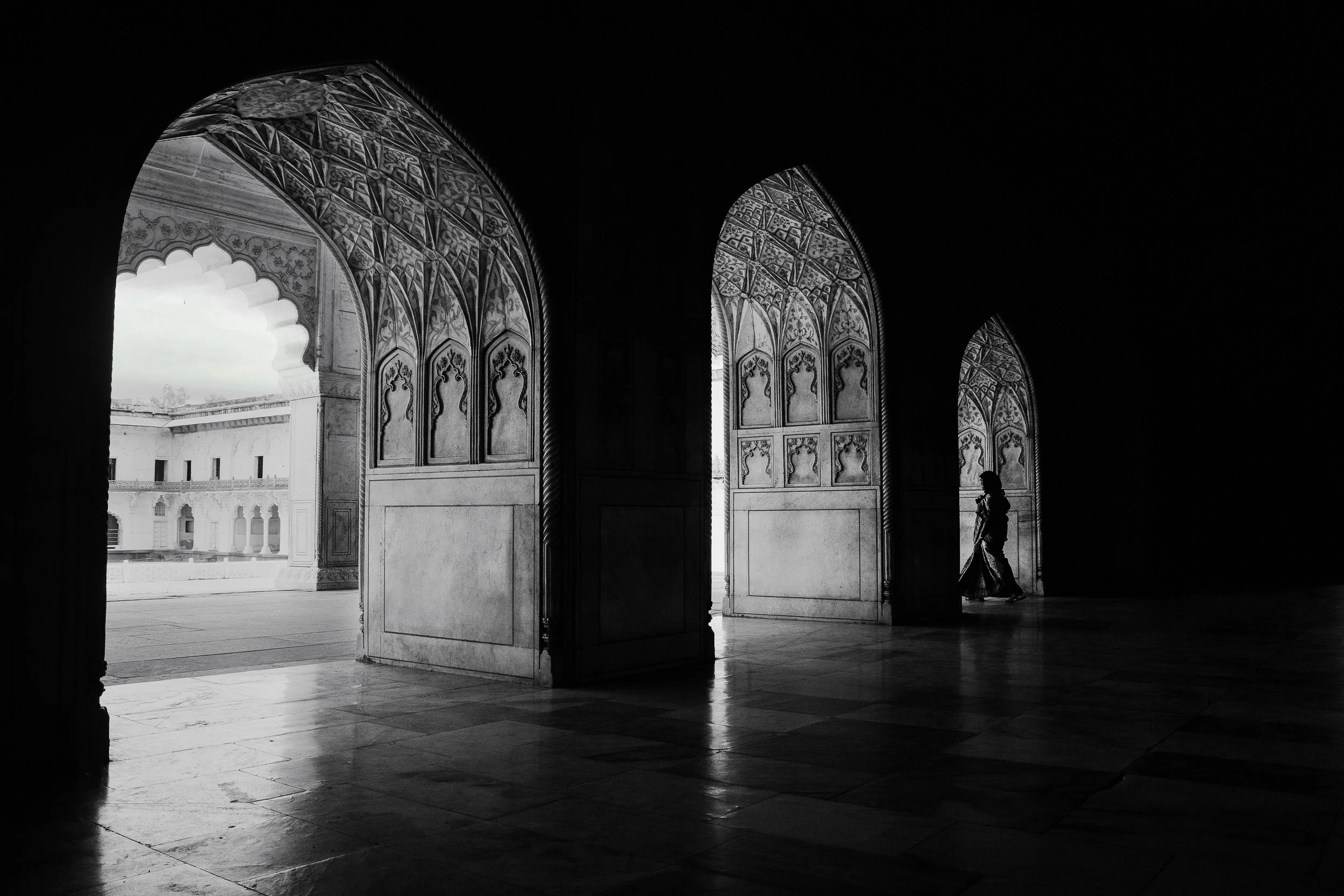 The light gets smaller with every arch. She's standing in the last one. — Agra, India. 2025