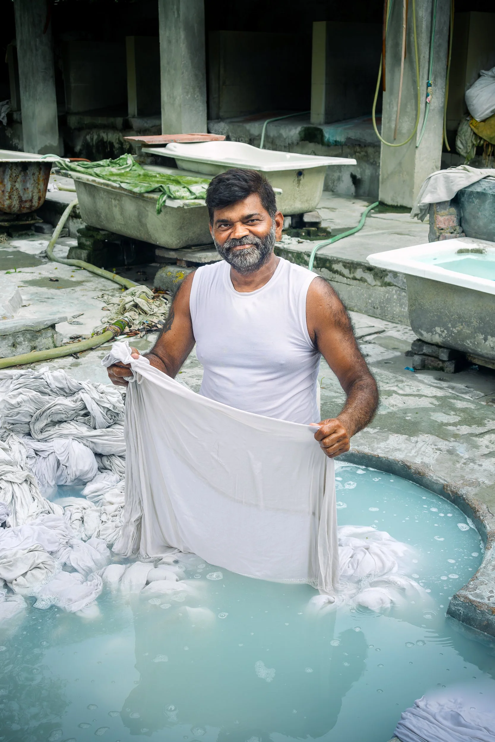 He looked up mid-wash like the camera was the interruption he'd been hoping for.