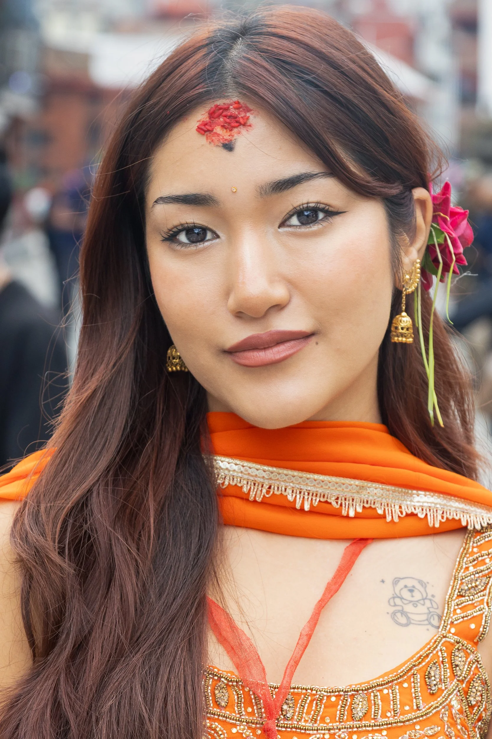 A stranger's gold. Her own small secret underneath it. Kathmandu, Nepal. 2026.