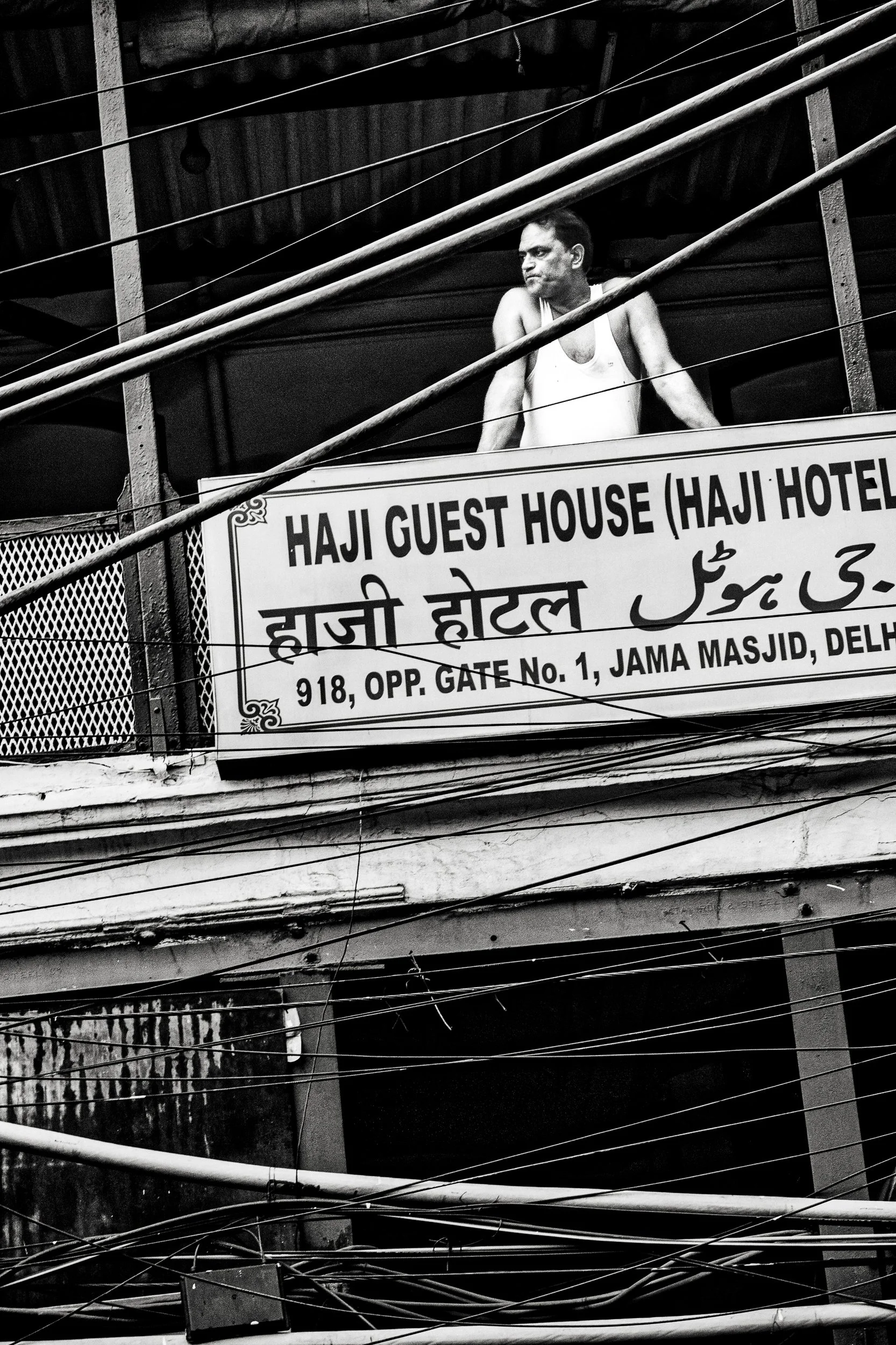 Everything wired below him, and still nowhere to plug in a name. New Delhi, India. 2025.