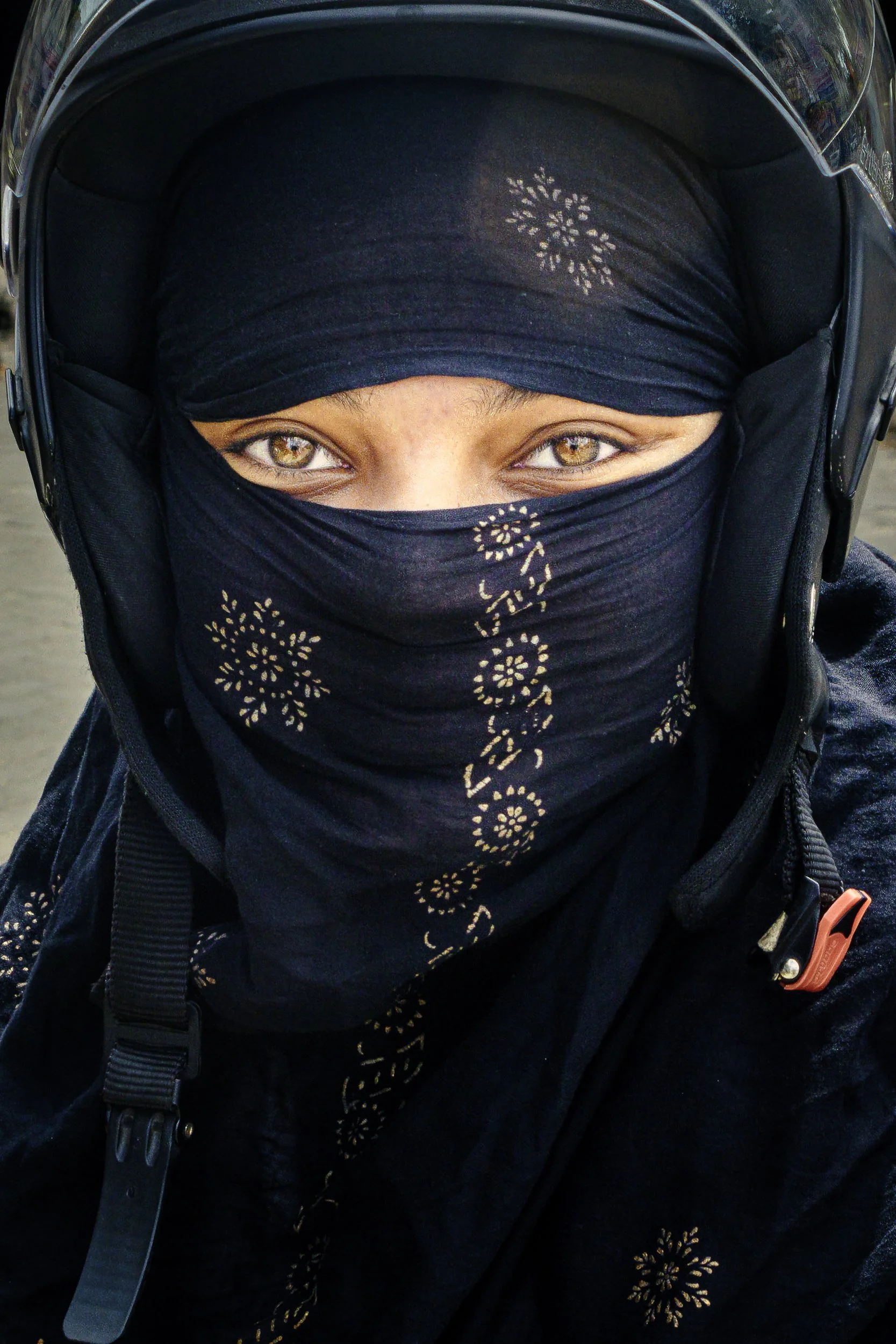 image of a girl with niqab on a motornike