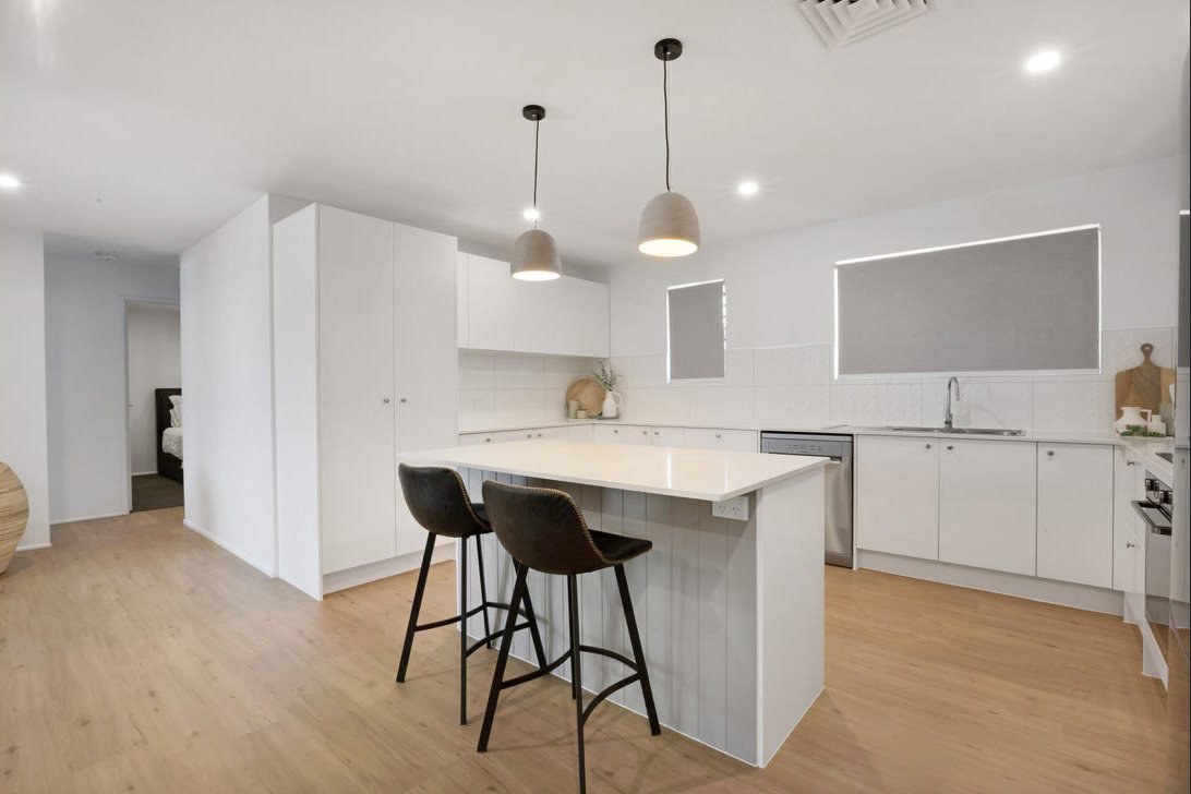 Kitchen renovation in Geelong with white cabinetry, island bench and pendant lighting
