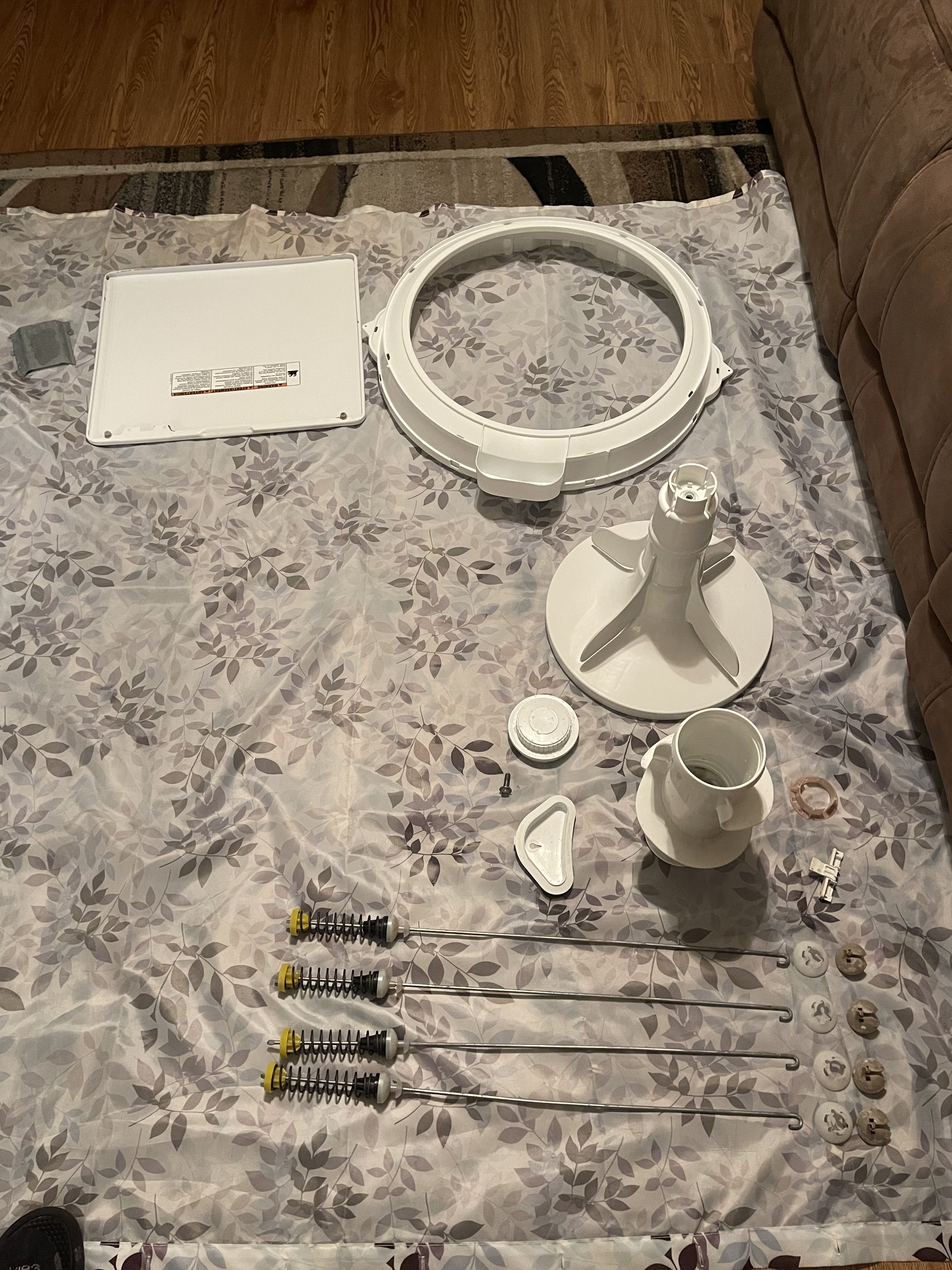 Disassembled washing-machine components organized during repair