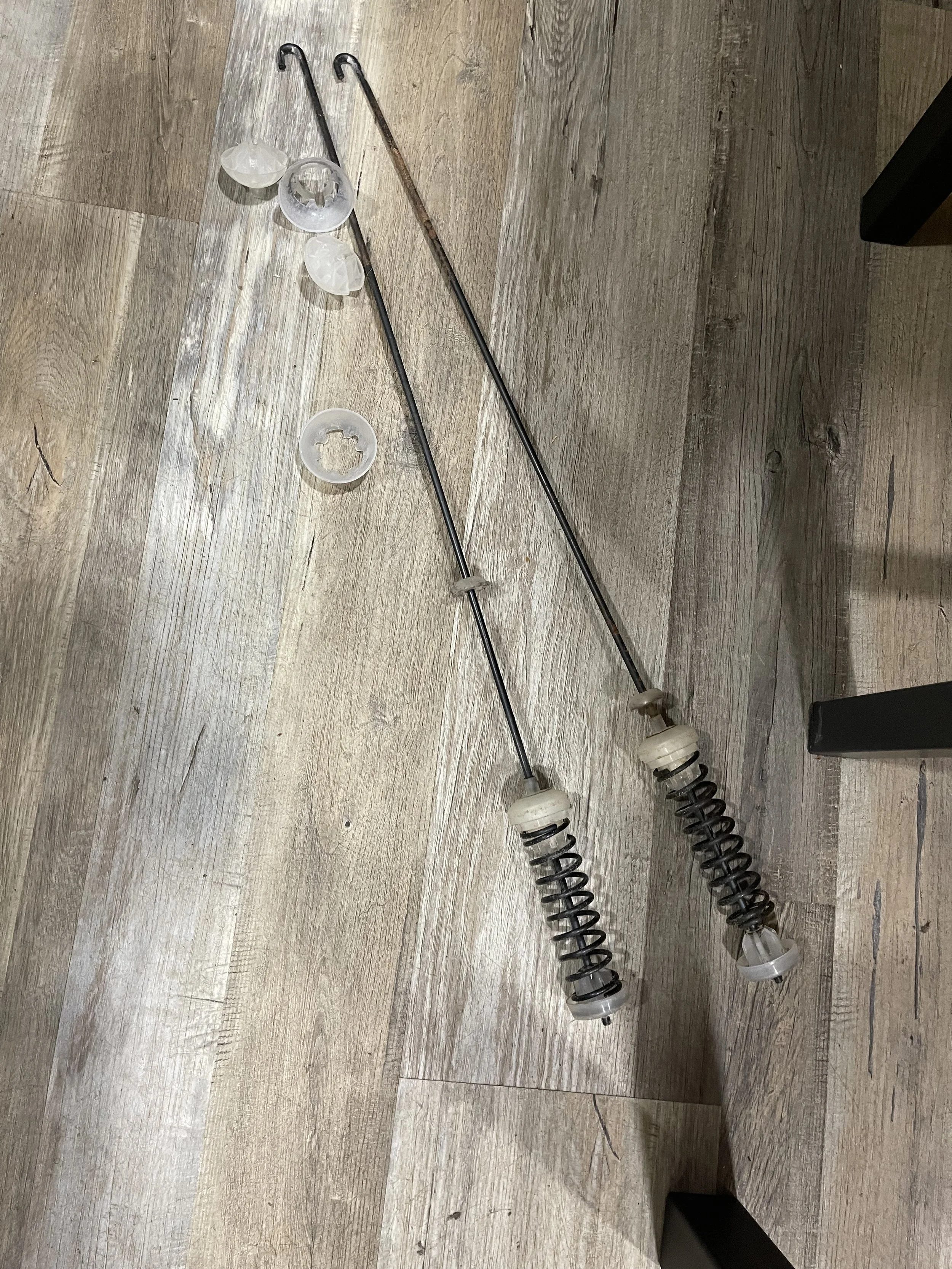 Worn washing-machine suspension rods removed during repair