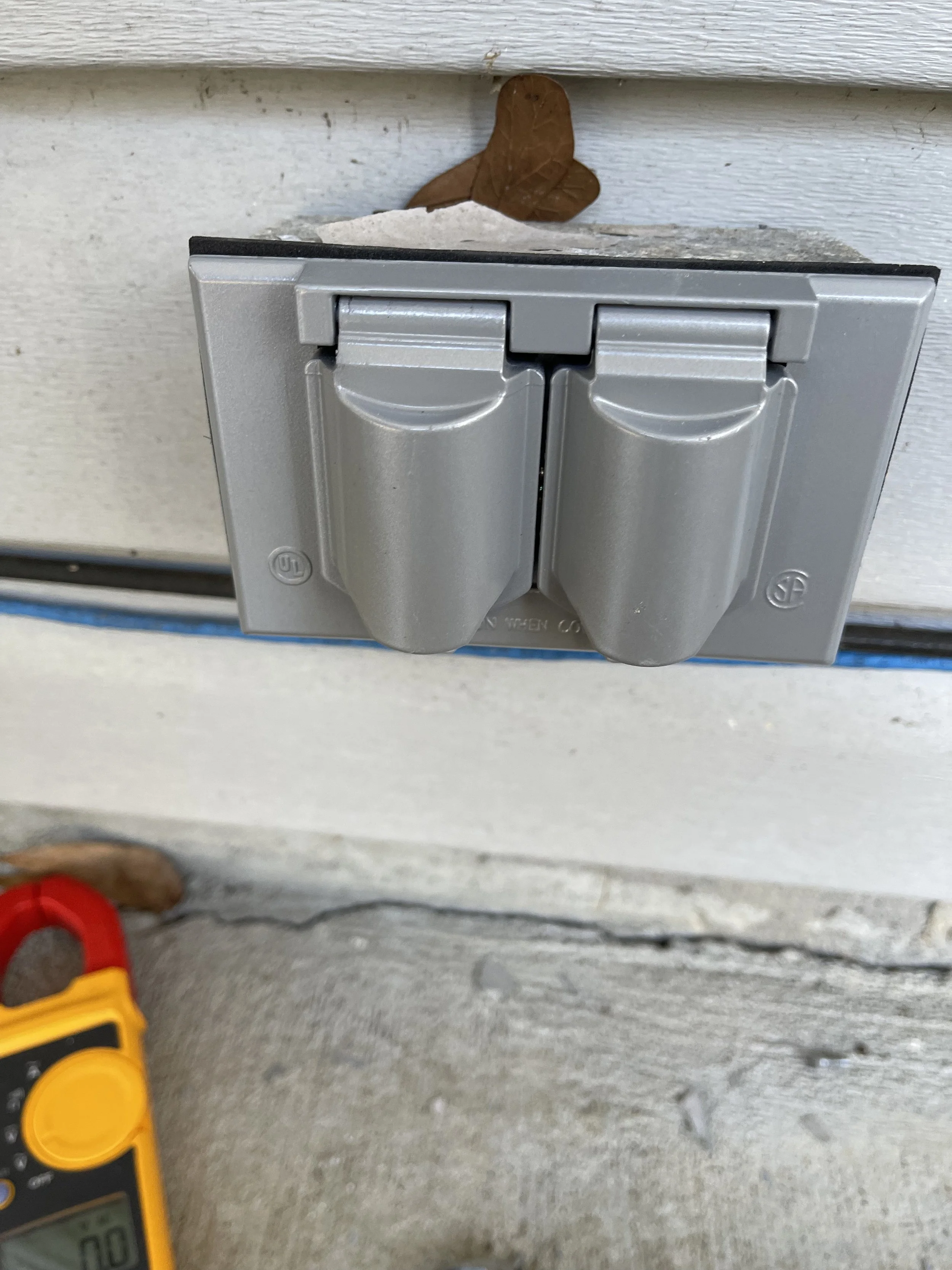 Weather-resistant outdoor outlet cover after replacement