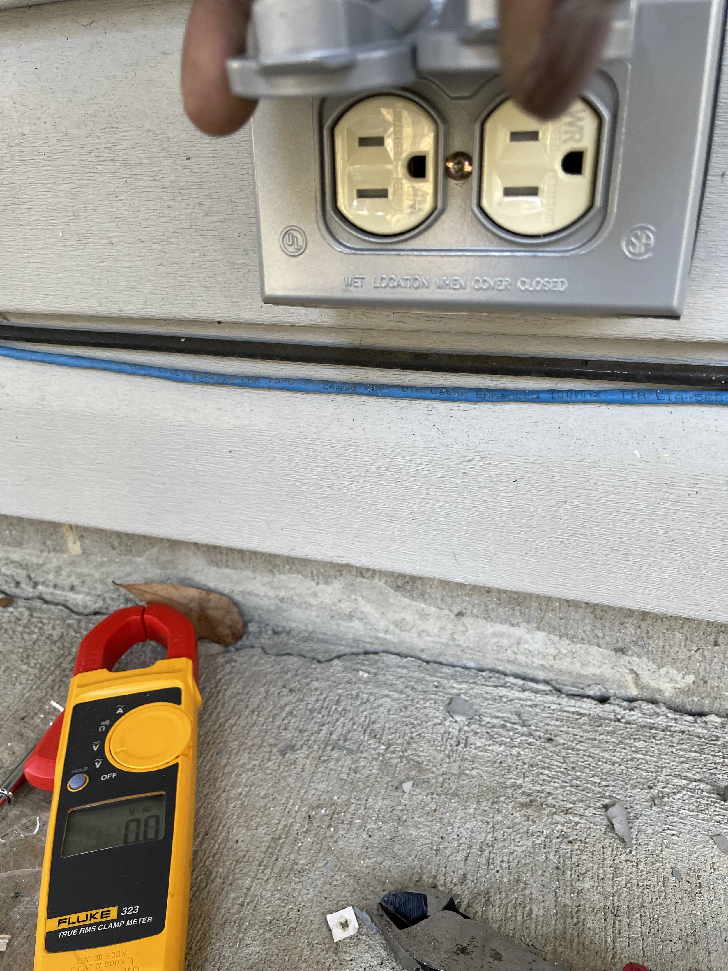 Testing voltage at an outdoor electrical receptacle