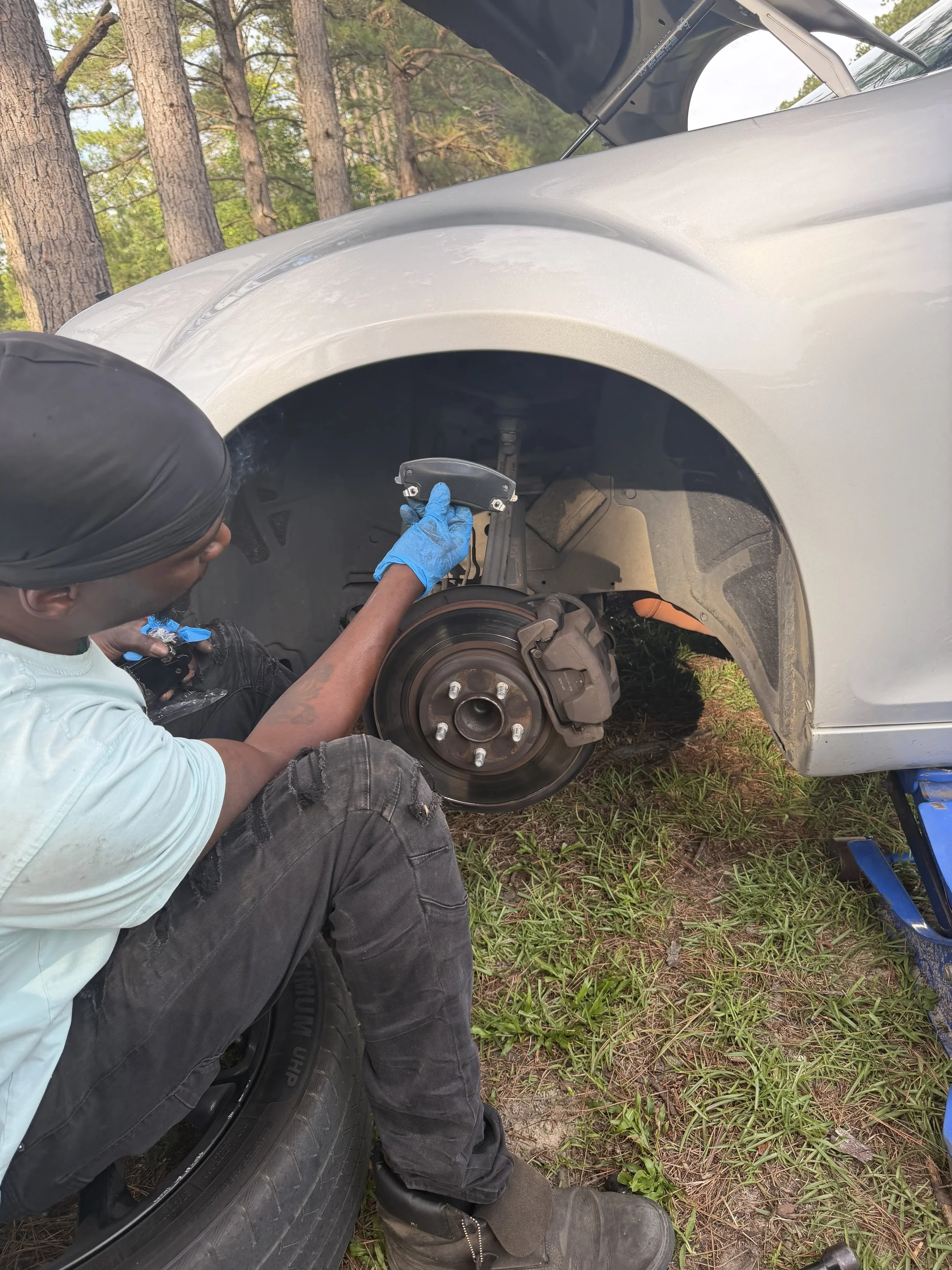 Wheel repair: Technician performing wheel and brake repair on a vehicle