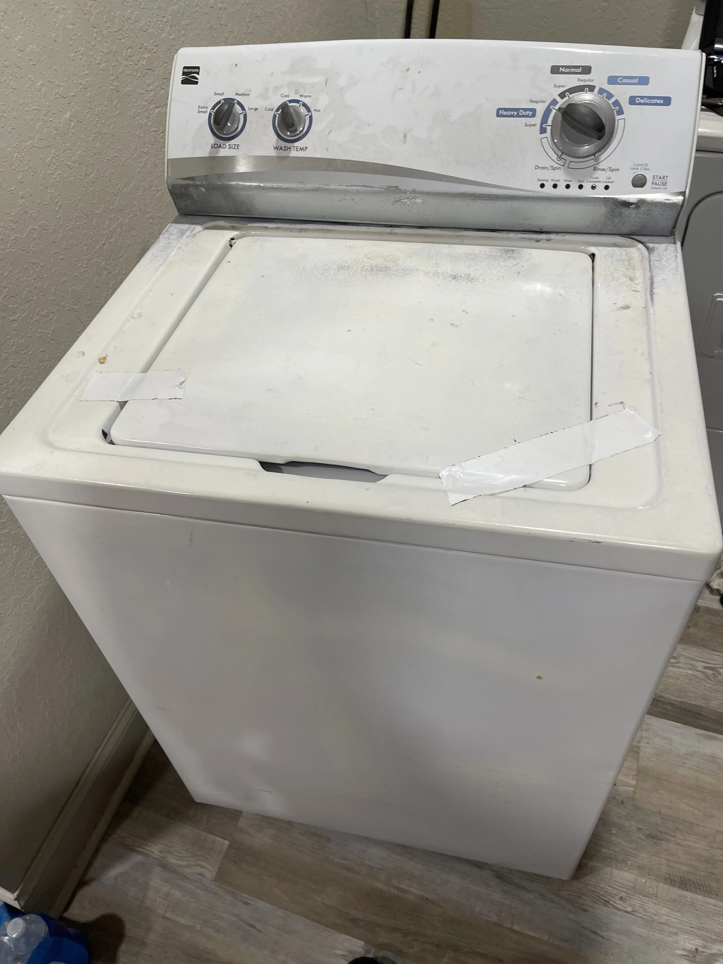 Washer interior: Top-loading washing machine opened for suspension-rod replacement