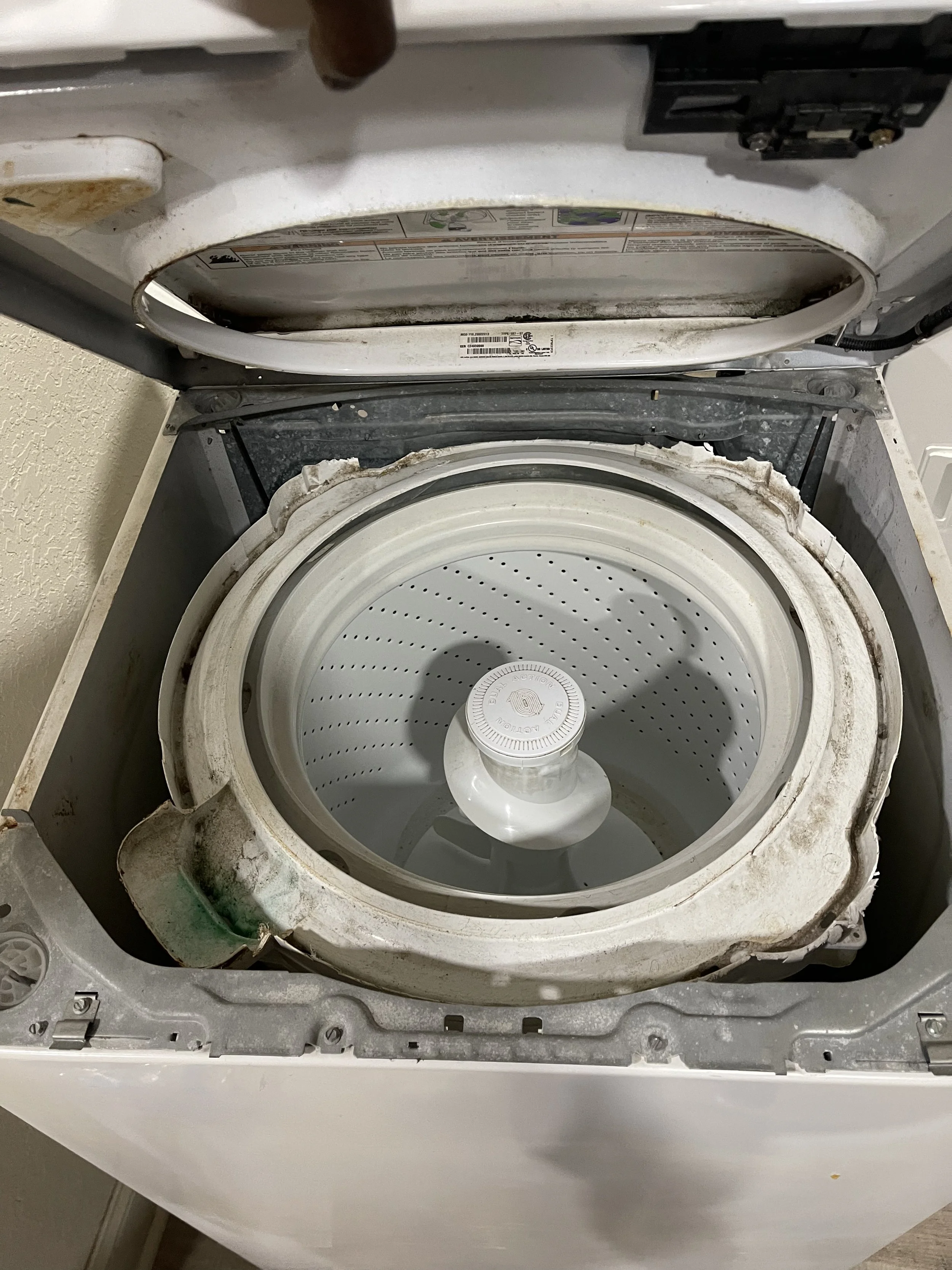 Washer interior: Top-loading washing machine opened for suspension-rod replacement