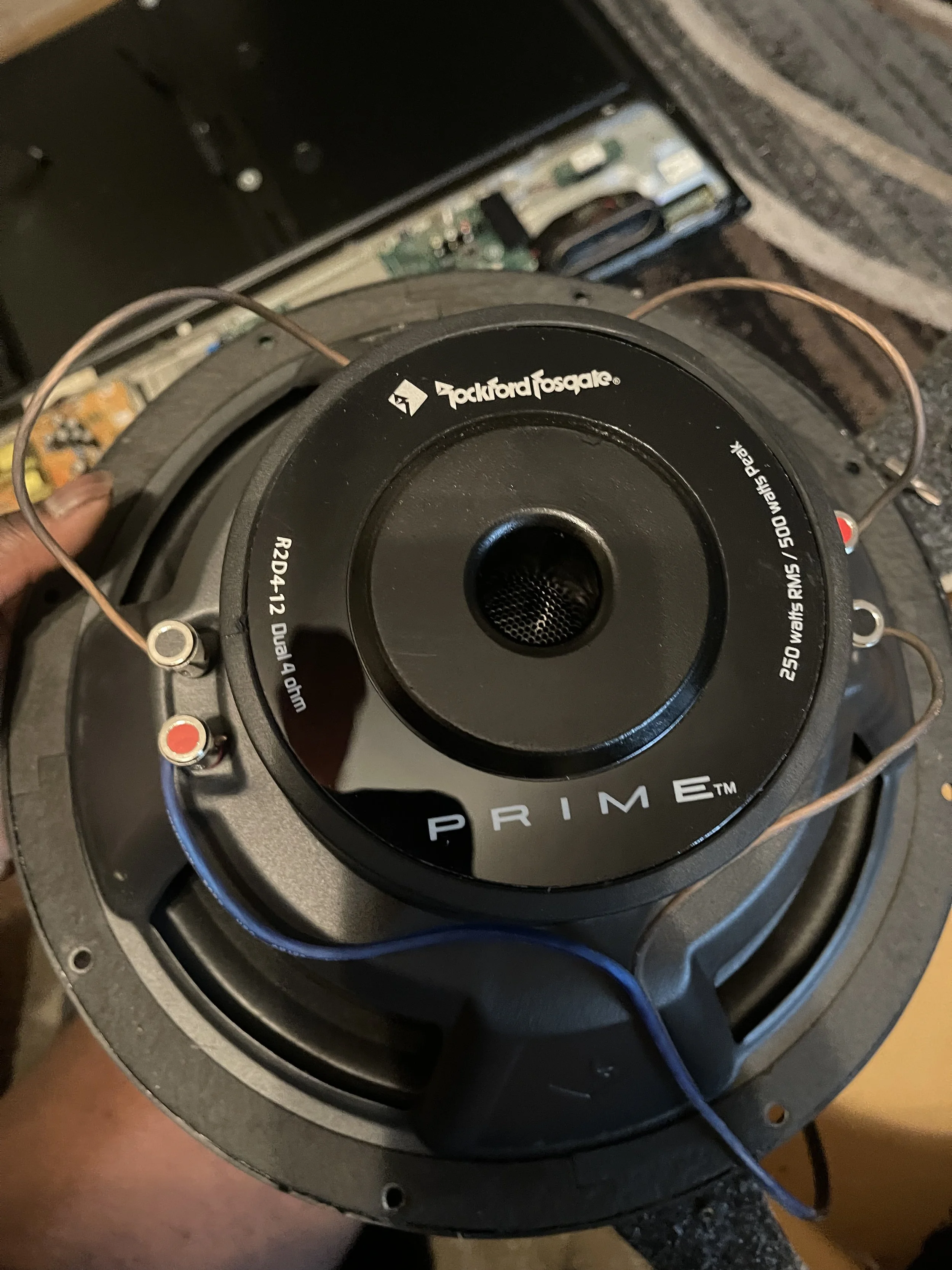 Close-up of a Pioneer speaker with a visible circuit board and wires in the background.