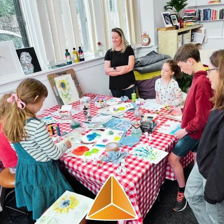 Kat at Shorelark with a class of children, making art projects.