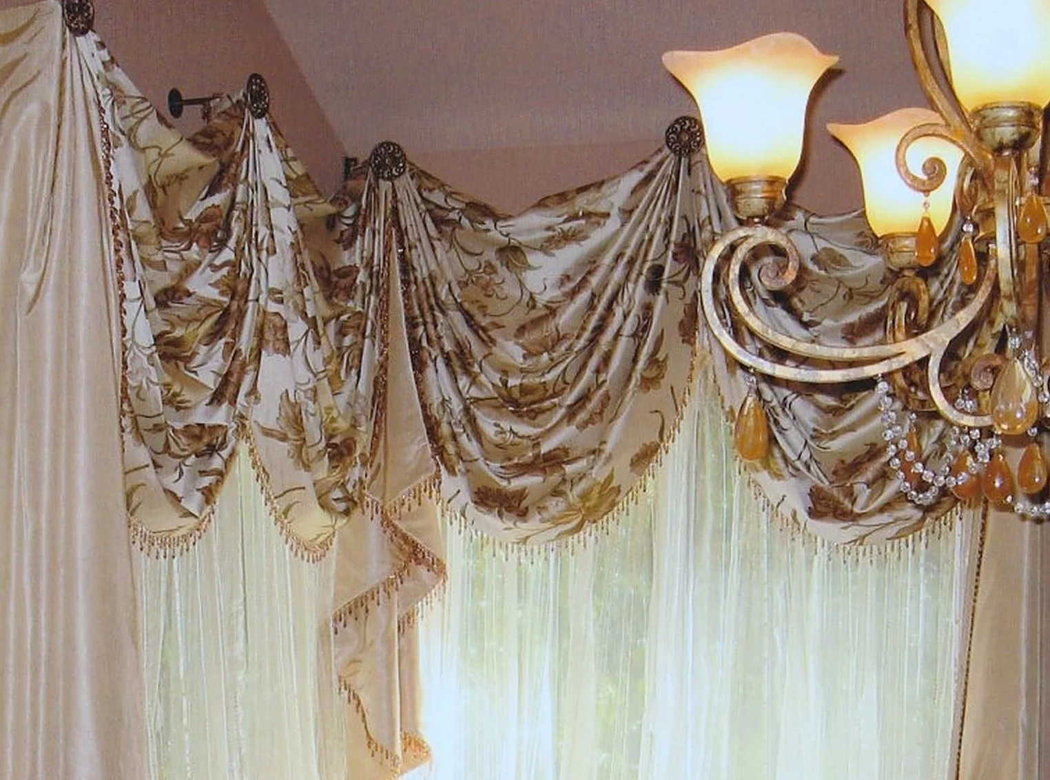 Silk swags and jabots with beaded trim on medallions