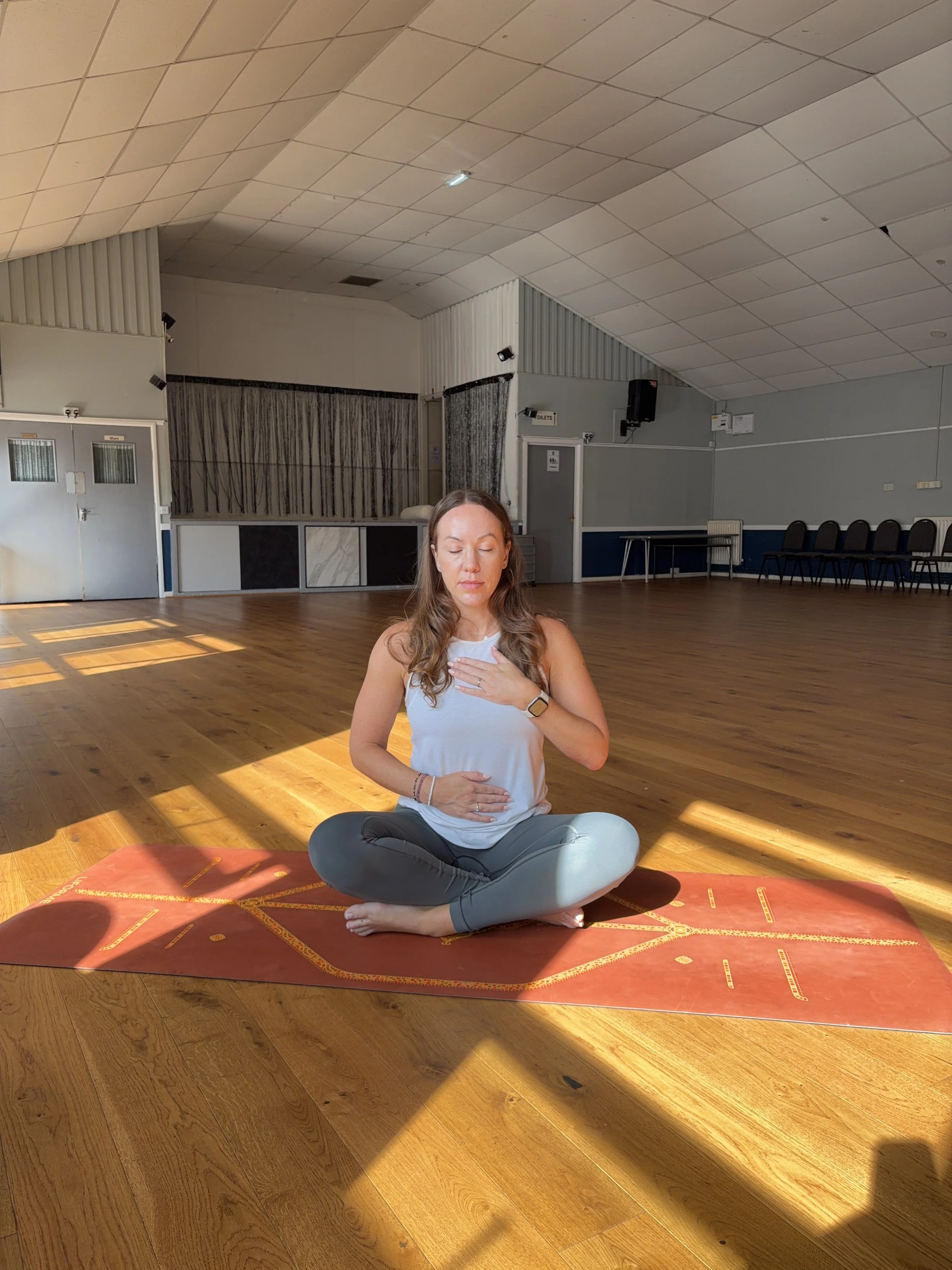 Chloe practising seated meditation during a Serene Yoga class at HEDCA in Gosport.