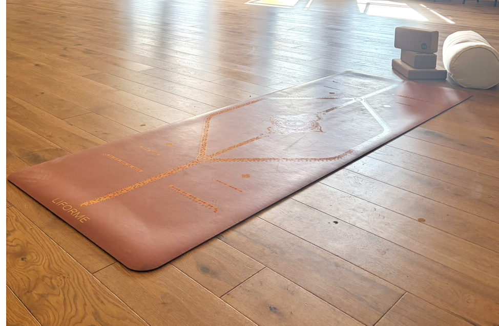 Yoga mat with yoga blocks and bolster on a wooden floor at HEDCA in Gosport.
