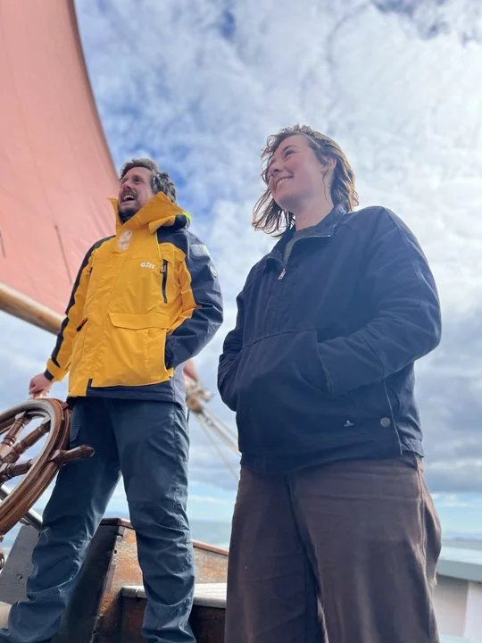 Guest crew steering provident with crew member over seeing.