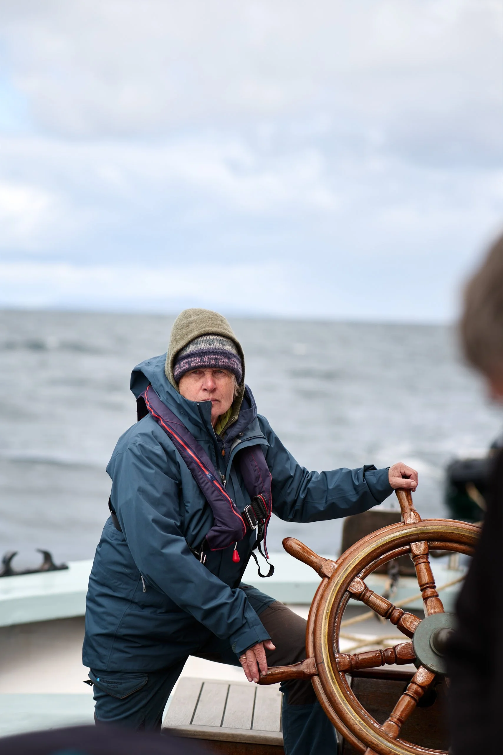Guest crew on he helm of Provident