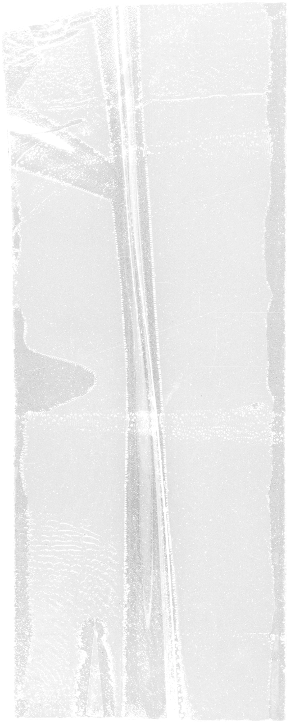 A frozen body of water with cracks, and a narrow ice road running through the center, surrounded by ice and snow.