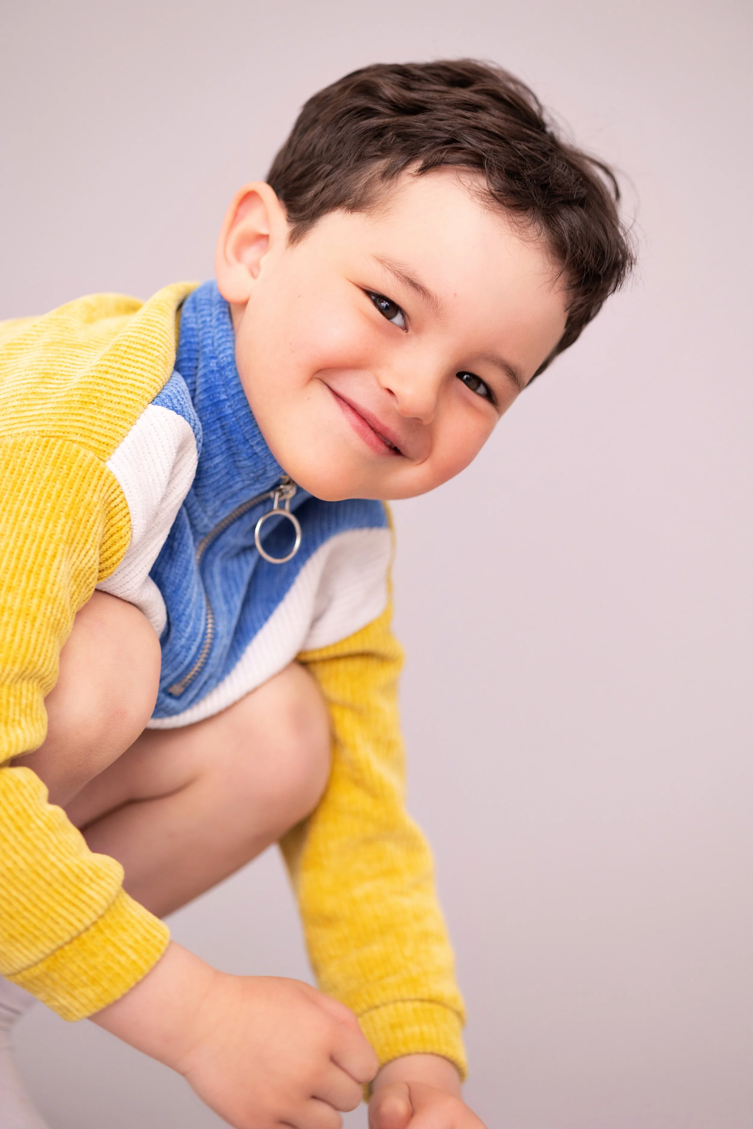 
Smiling young boy during a relaxed child model headshot and portfolio update session.
