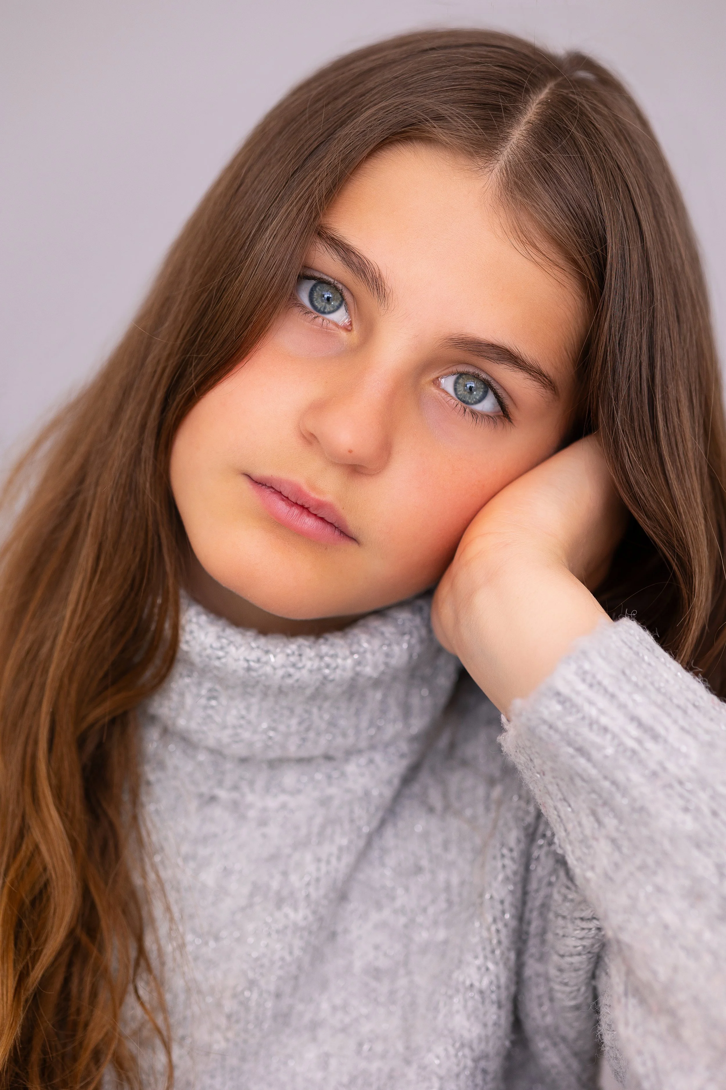 Close-up child model headshot showing a natural expression for a modelling portfolio update.
