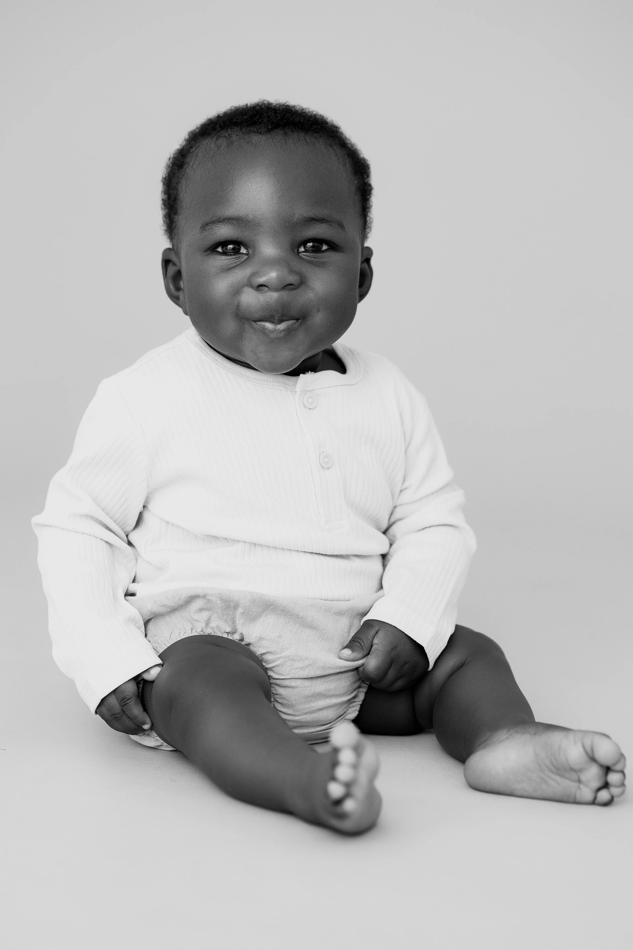 Black and white portrait of a baby boy during a child model portfolio photography session.
